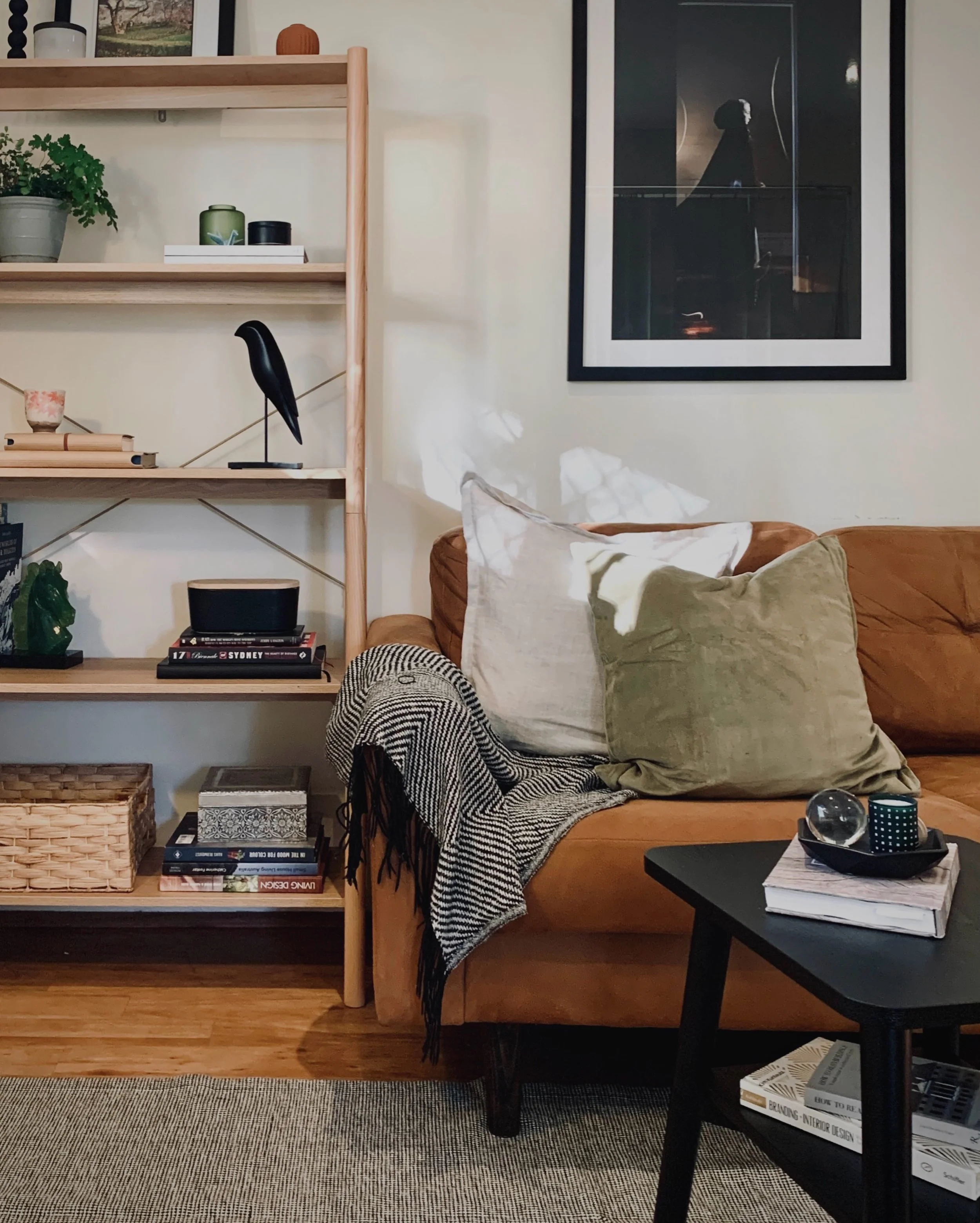 With open shelving, I like to leave some breathing room rather than filling every surface.

Here, the warm timber carries most of the visual weight, with black accents repeated through the room to give the shelving a bit more structure. Books, cerami