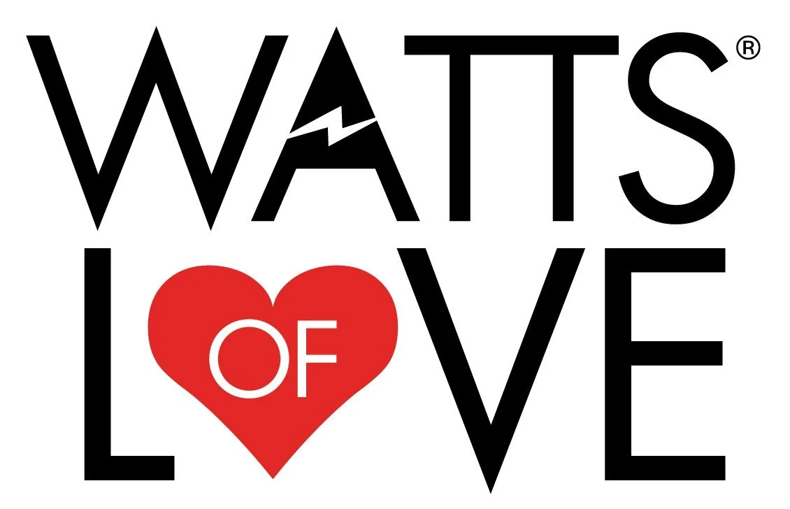 Logo with the words 'WATTS of LOVE' inside a dark blue circle, featuring a heart with rays above and a red heart replacing the 'O' in love.
