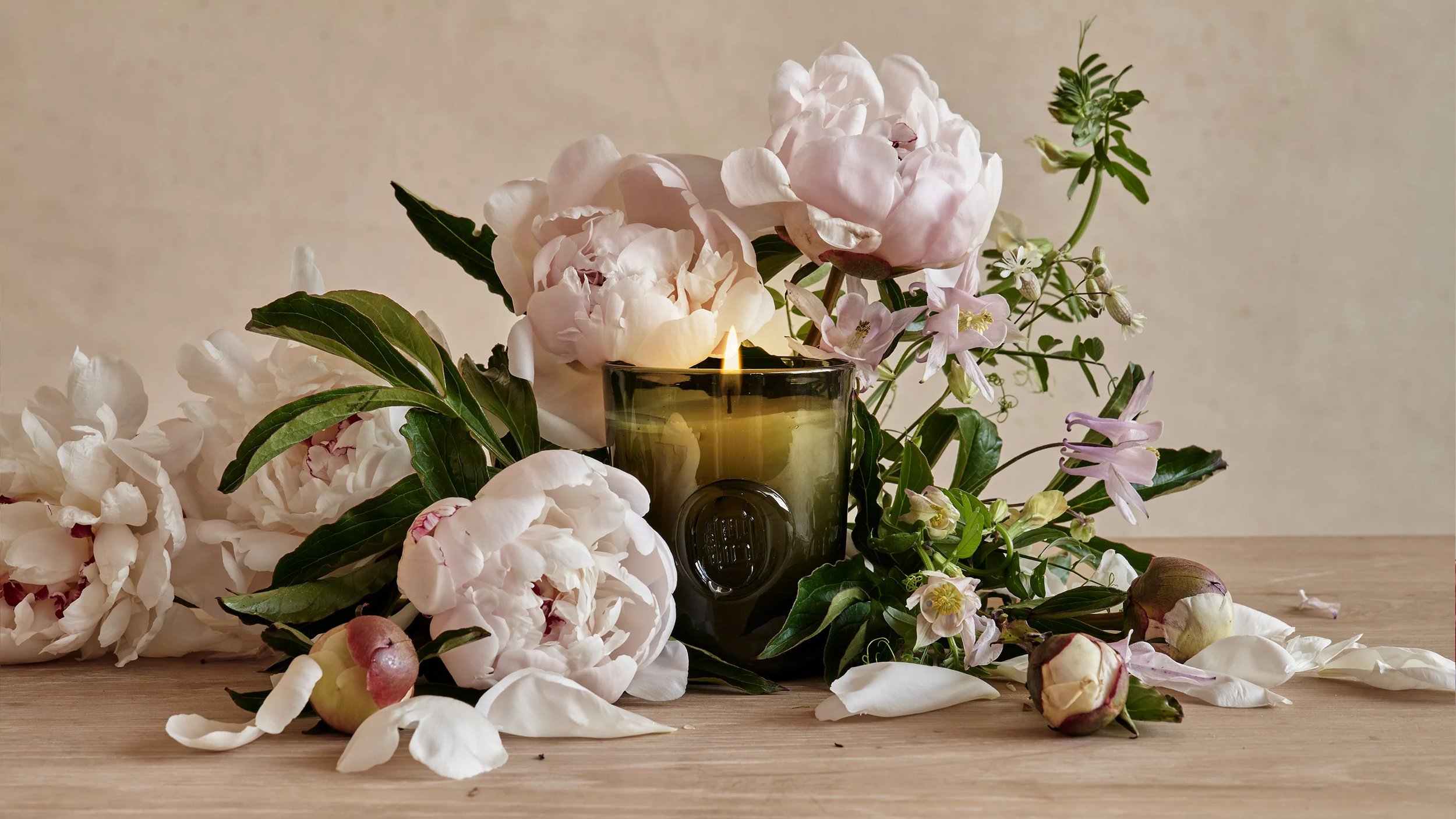 Roman and Williams Guild Candle Displayed with Peony Flowers