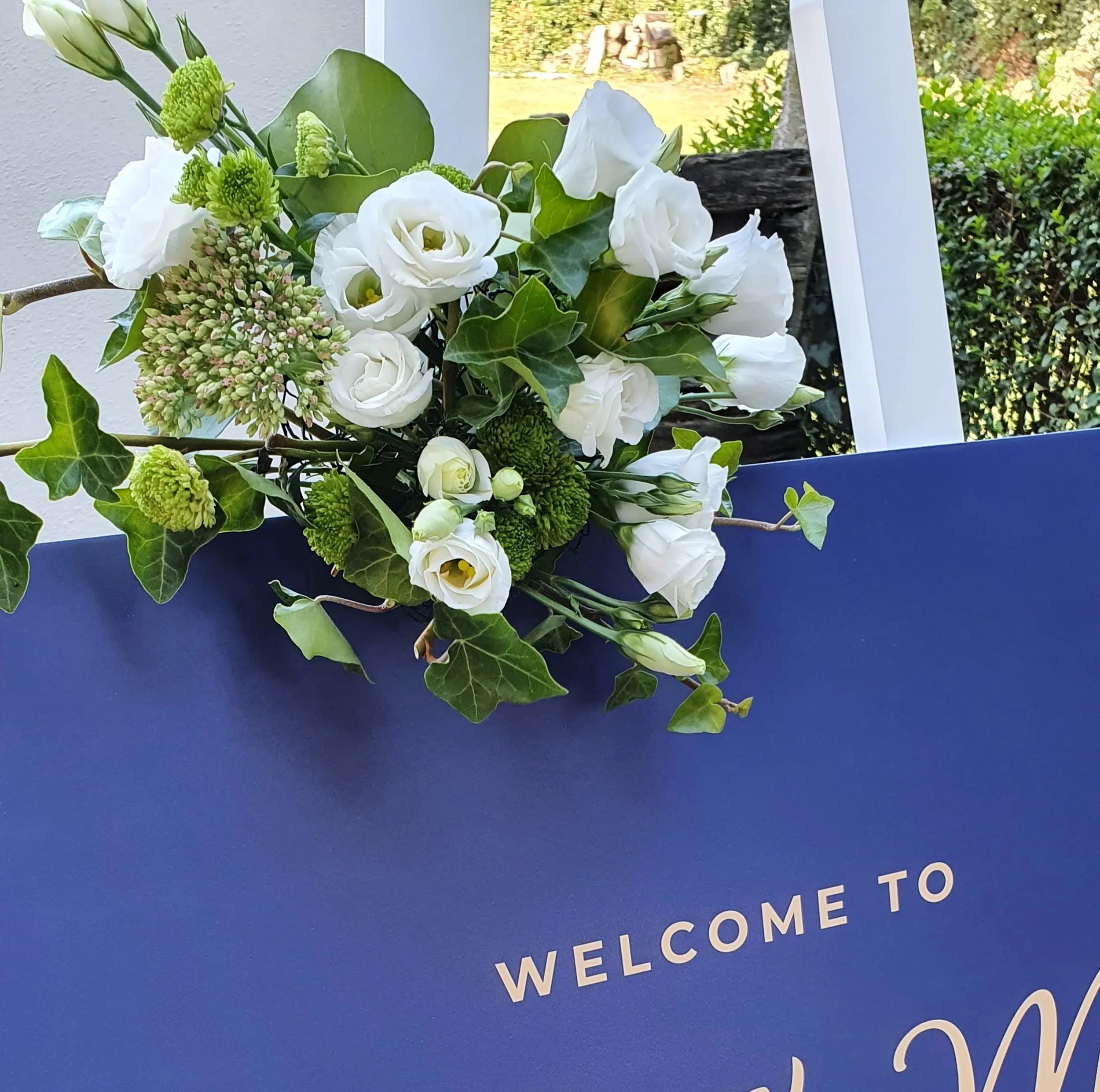 Bloemstuk op welkomstbord huwelijk.