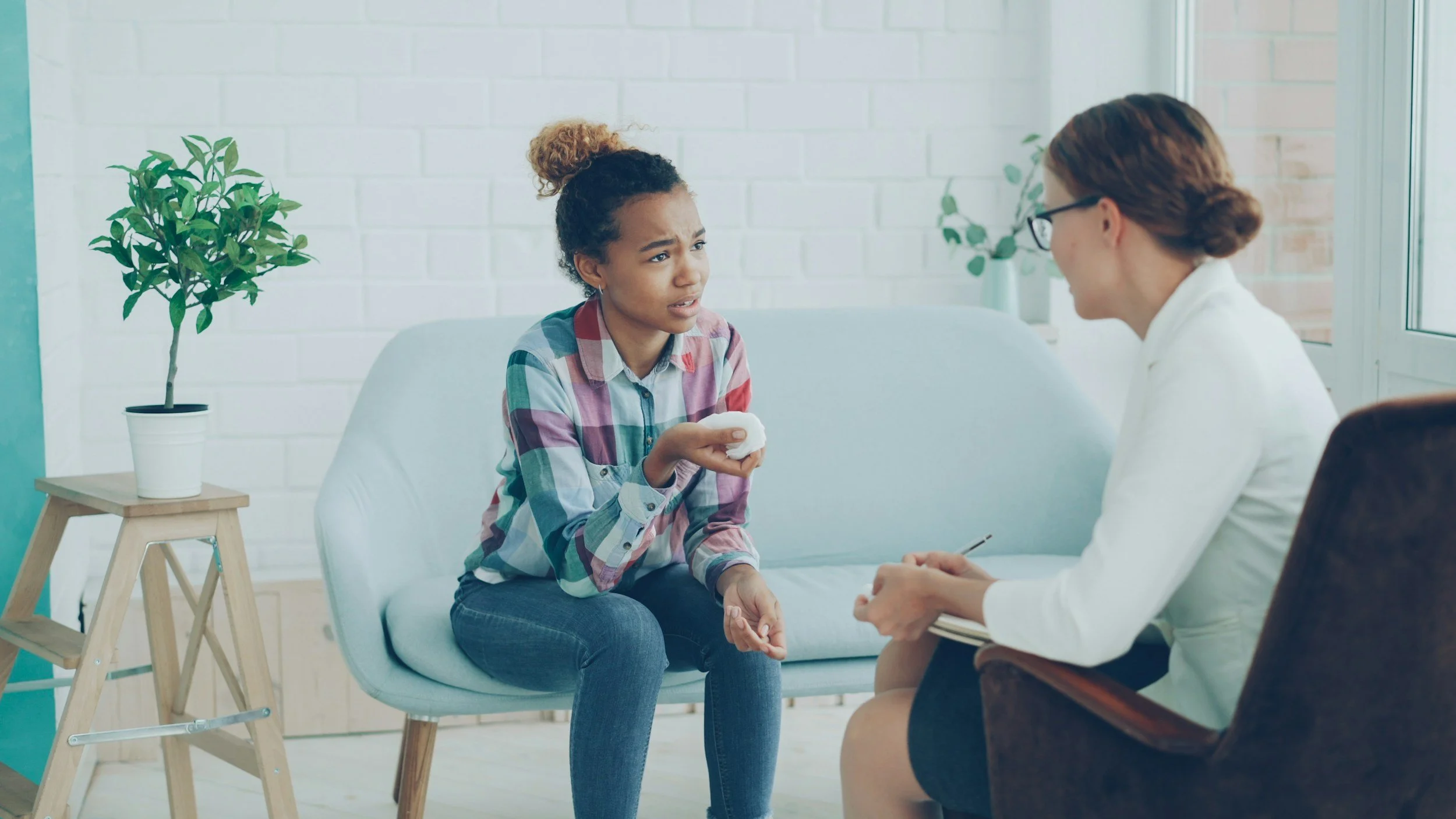 A doctor listening to her patient share her emotions