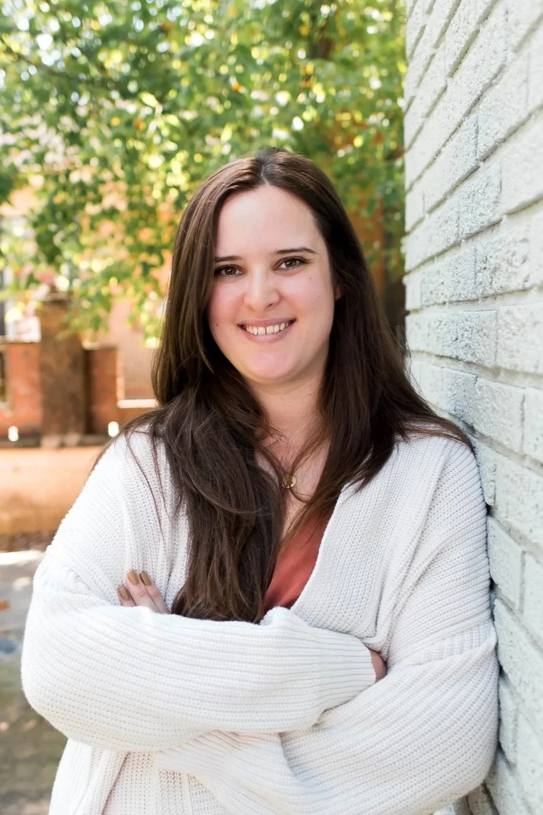 Headshot of Destiny Davis, LPC, CRC, presenter of the Living in Limbo CEU workshop, smiling outdoors against a white brick wall.
