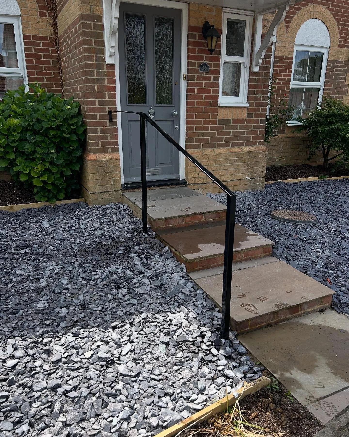 Simple handrail designed, fabricated, powder coated and installed locally.