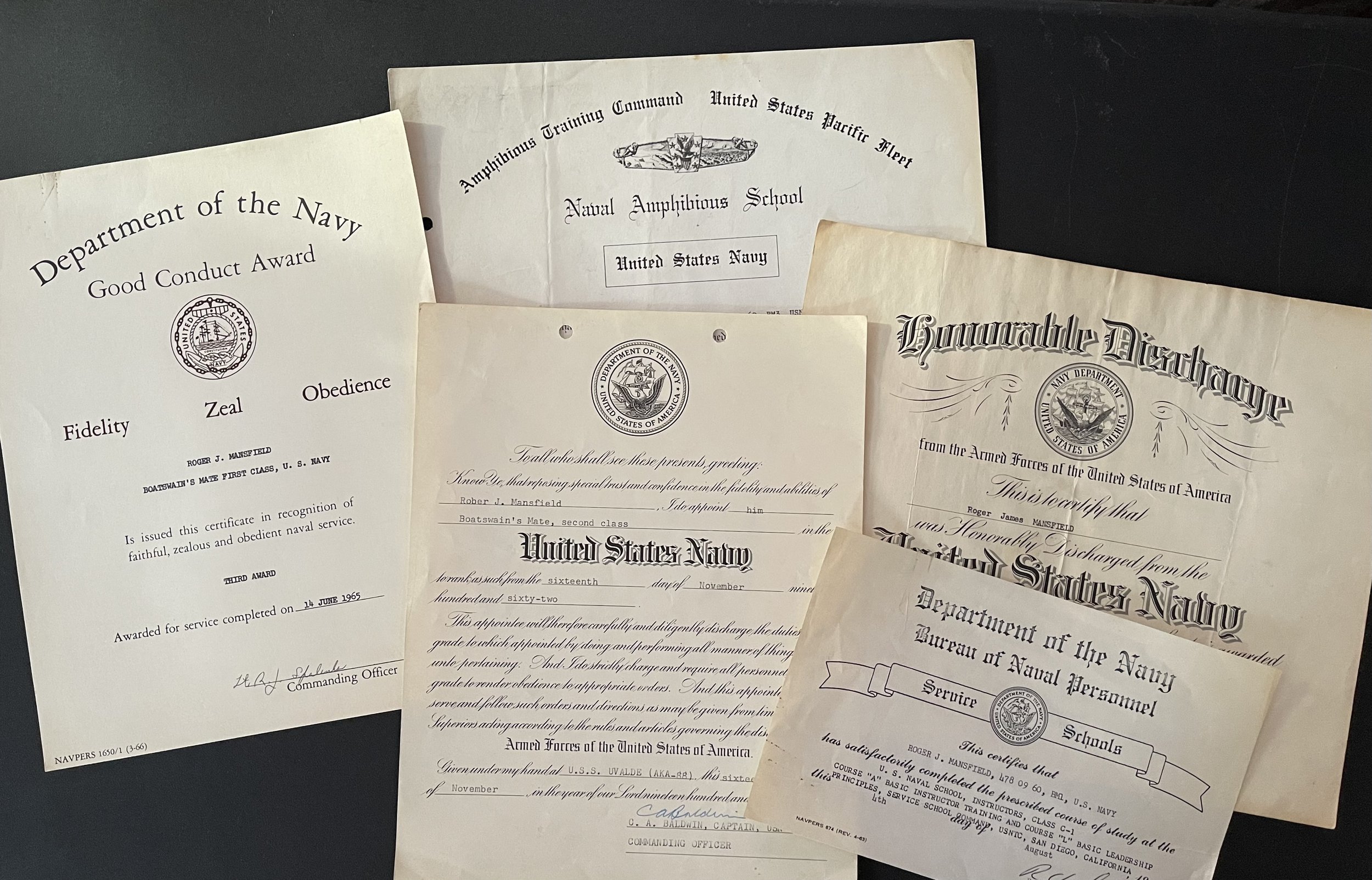 Collection of vintage navy military certificates and diplomas, including awards, training, and service documents from the United States Navy.