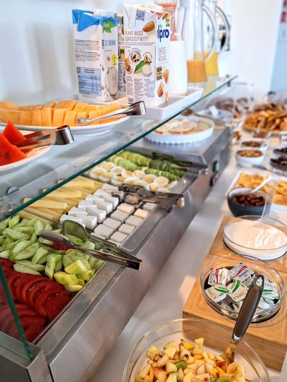 Ein üppig ausgestattetes Frühstücksbuffet mit Gemüse, Käse, Obst, Joghurt und vielem mehr in der Yoga Retreat Location in Griechenland 2026
