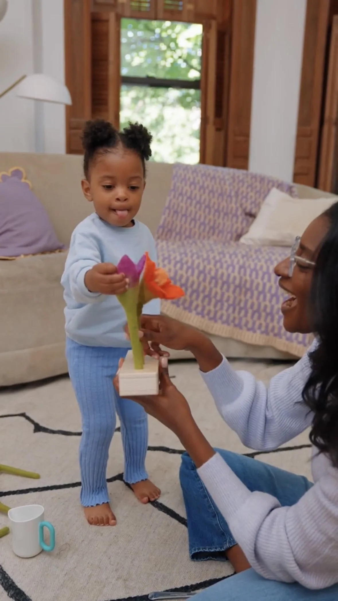 Pediatric speech therapist playing with a toddler during a speech therapy session.