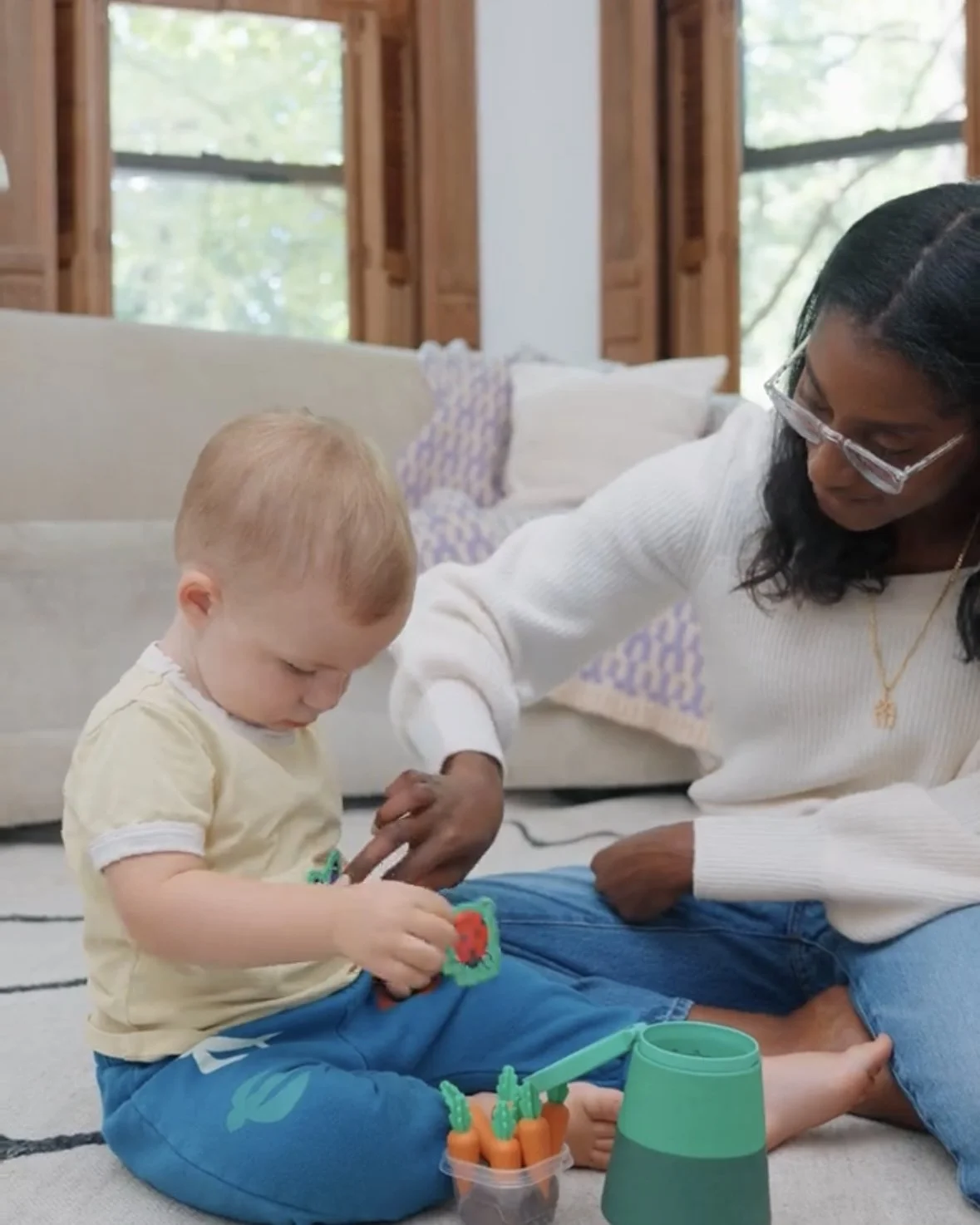Pediatric speech therapist playing with a toddler during a speech therapy session. 