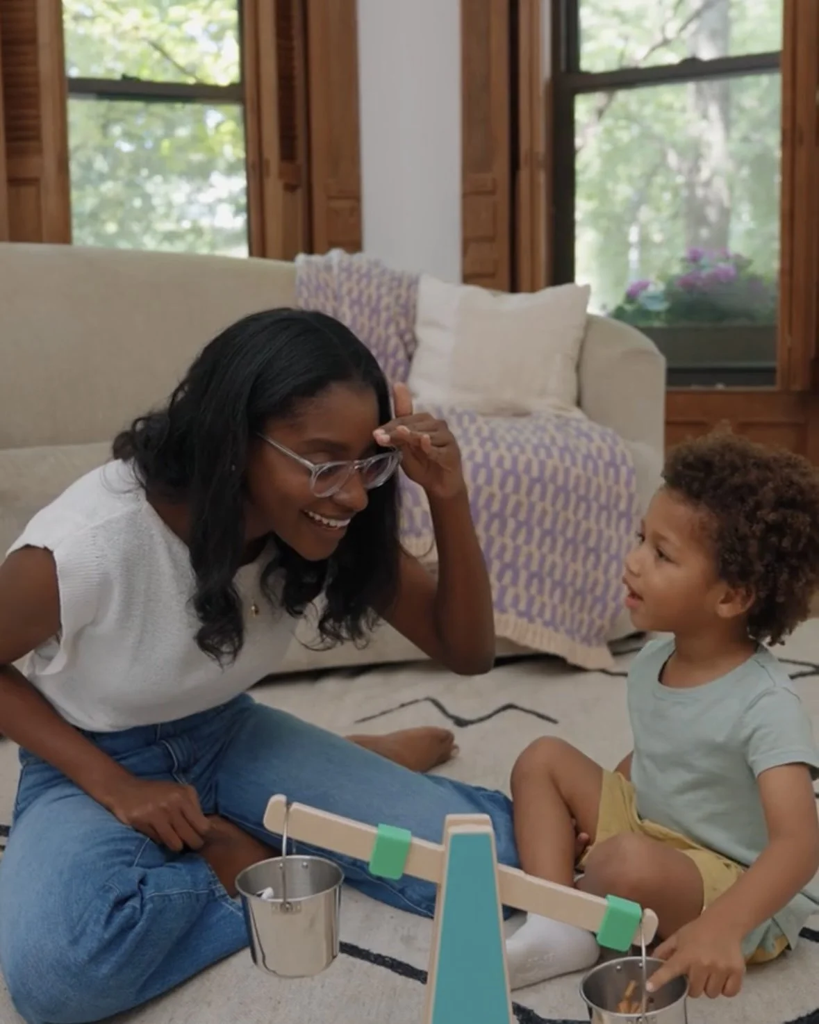 Pediatric speech therapist playing with a toddler during a speech therapy session.