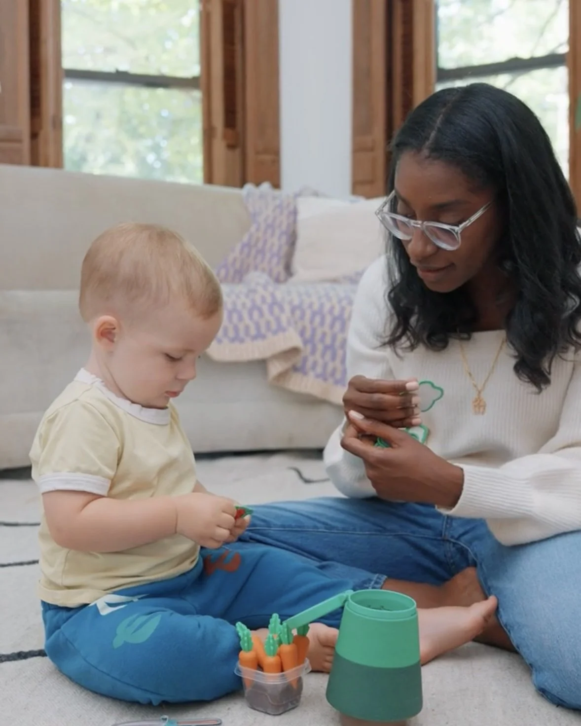 Pediatric speech therapist playing with a toddler during a speech therapy session. 