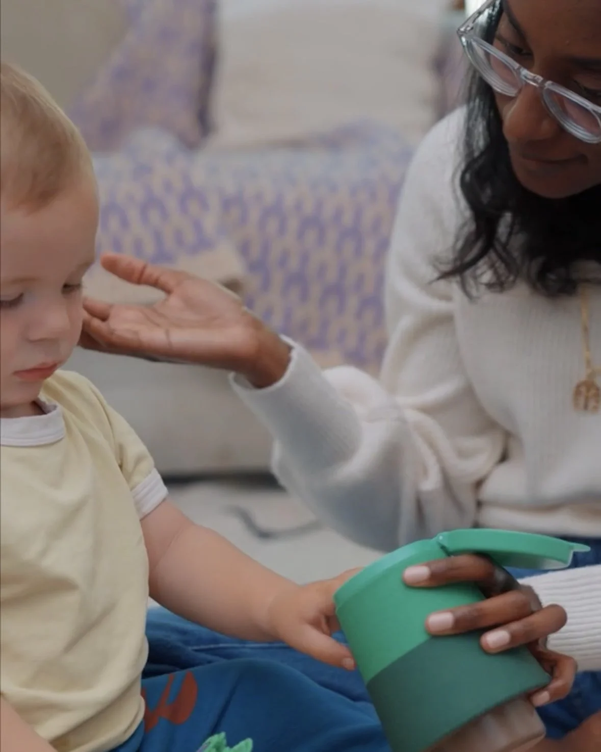 Pediatric speech therapist playing with a toddler during a speech therapy session. 