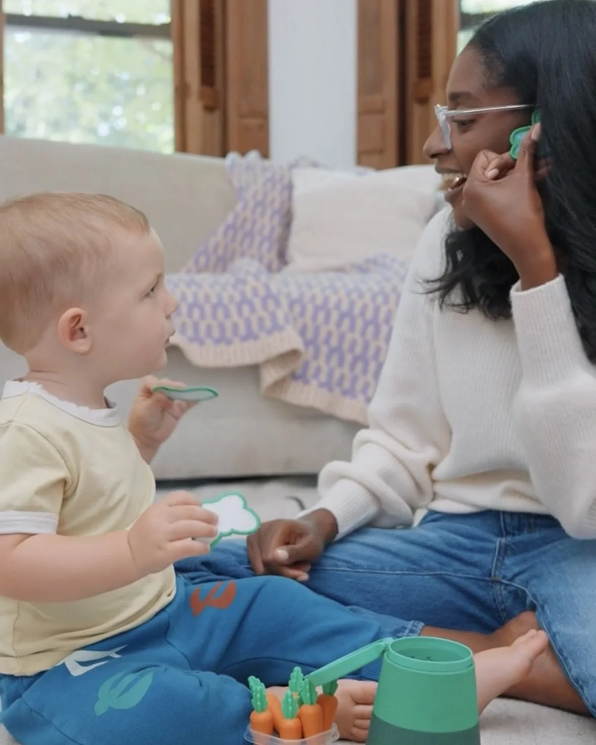 Pediatric speech therapist playing with a toddler during a speech therapy session. 