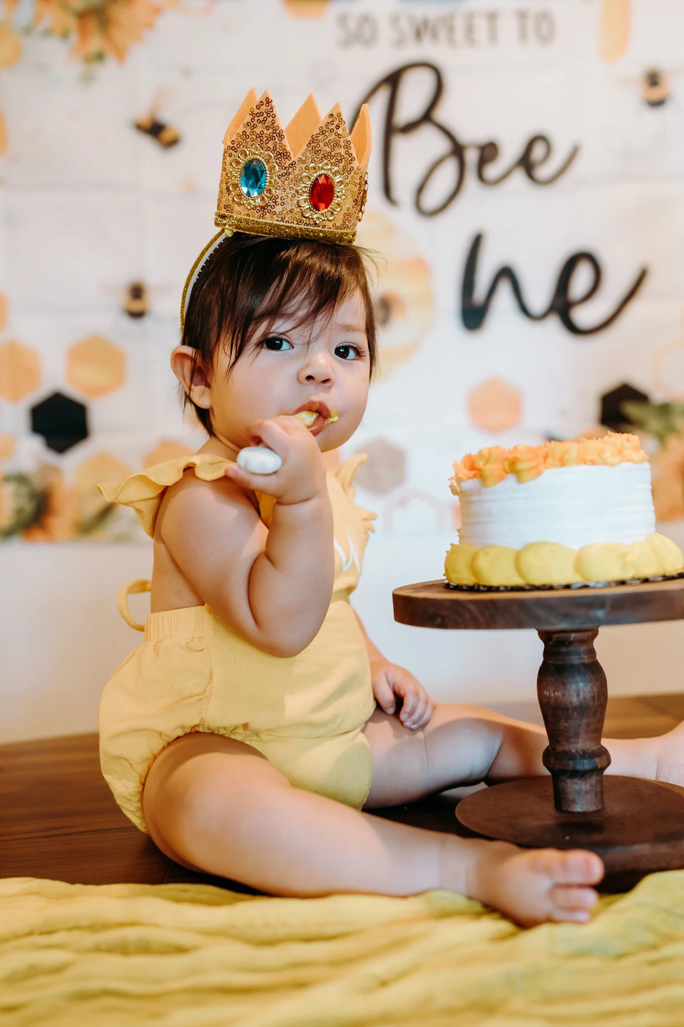 baby girl first birthday eating cake