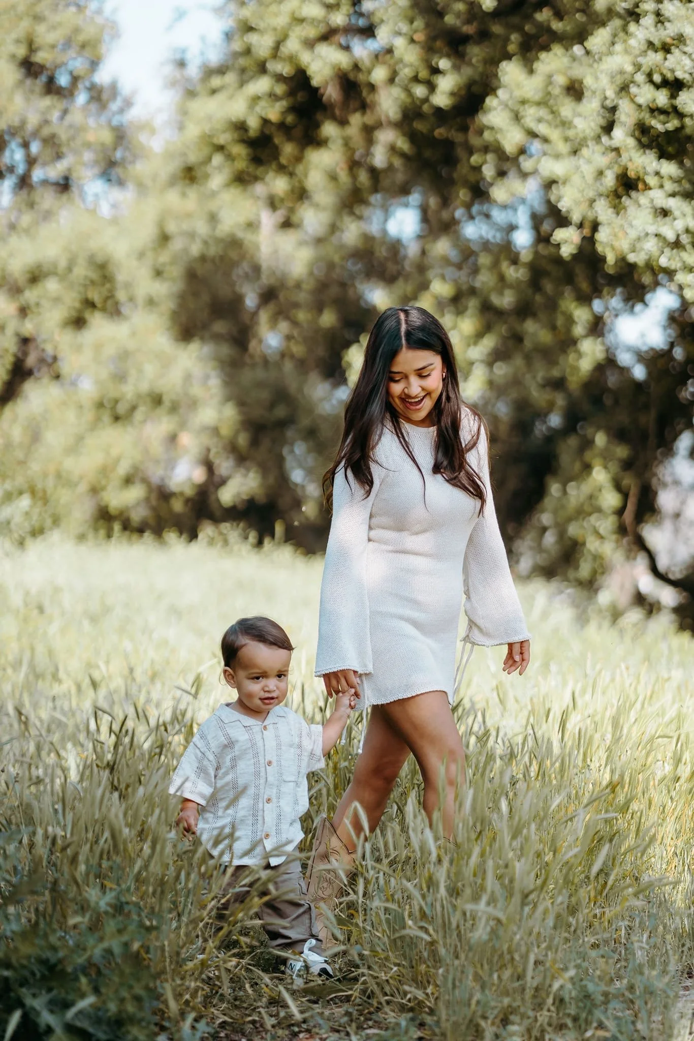 Mom walking holding hands with toddler son in La Verne California