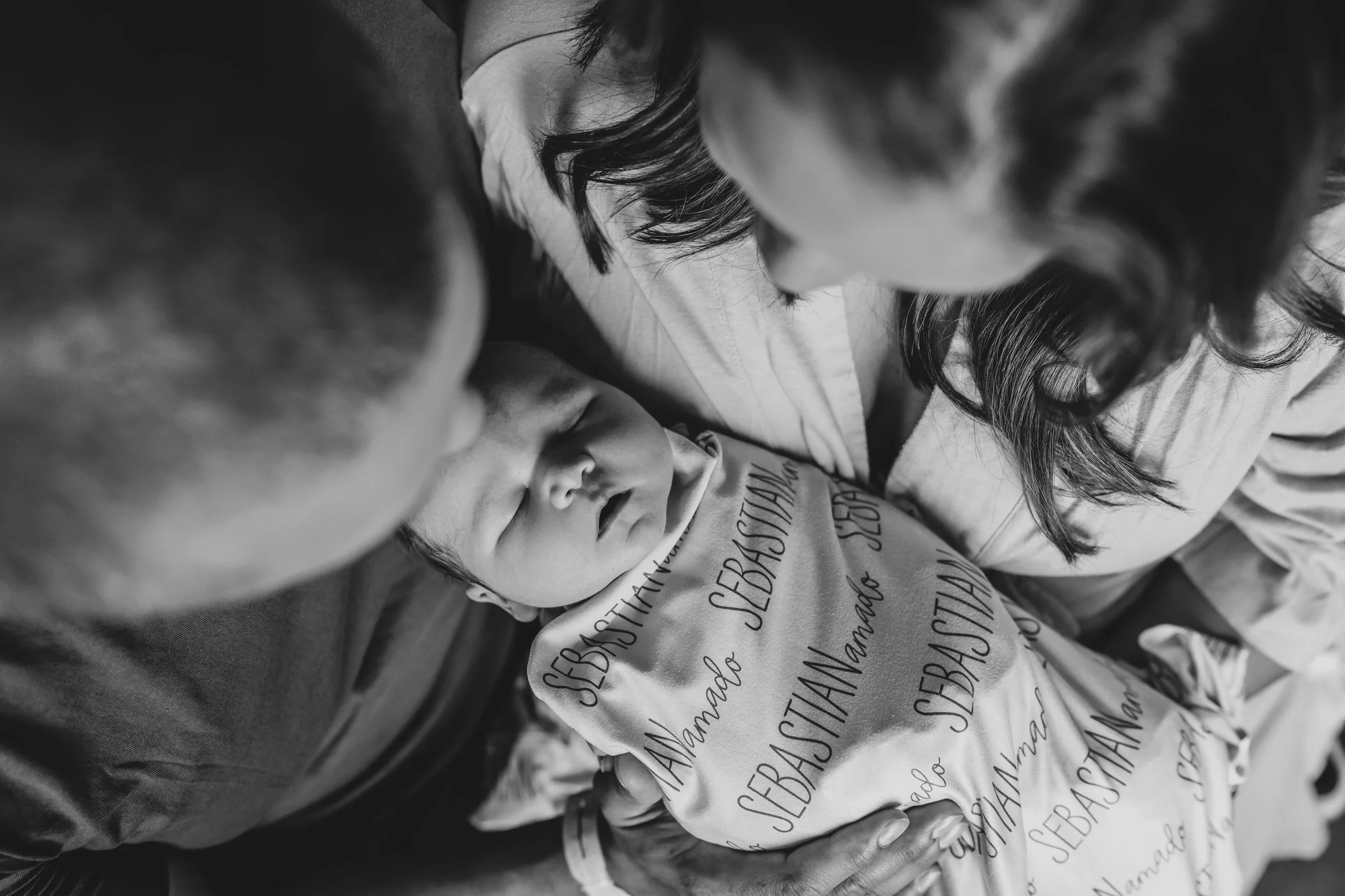 Parents holding newborn in the hospital black and white photo