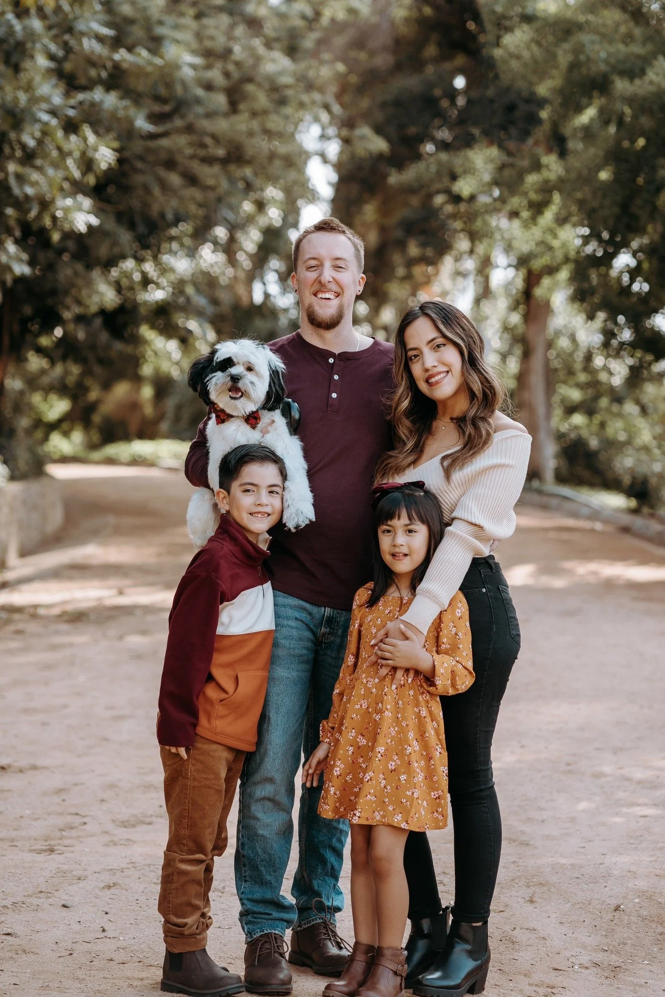 a family with a mom dad with son and daughter and their pet dog