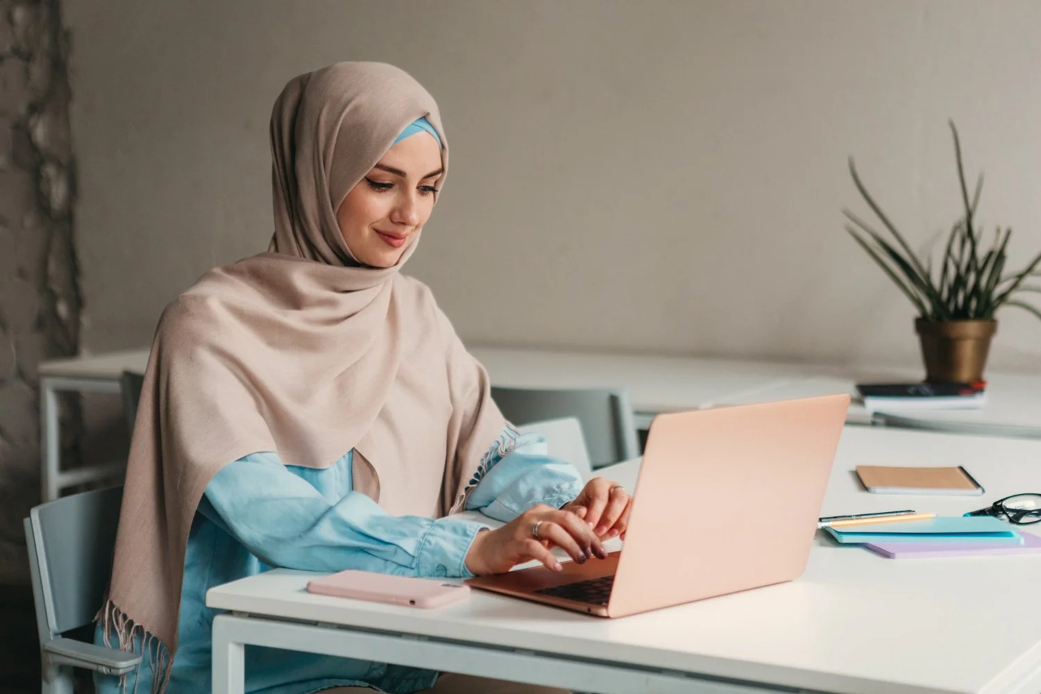 Muslim woman working on laptop