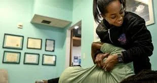 Patient receiving manual therapy on their shoulder from a physical therapist at a performance physical therapy clinic in Arlington, VA