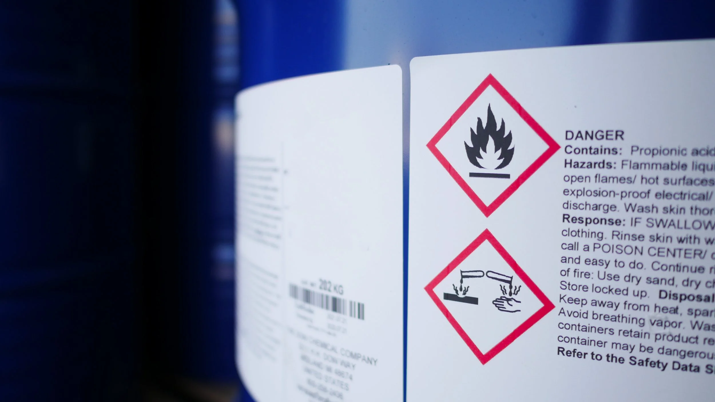 Chemical container label displaying WHMIS flammable and corrosion hazard pictograms