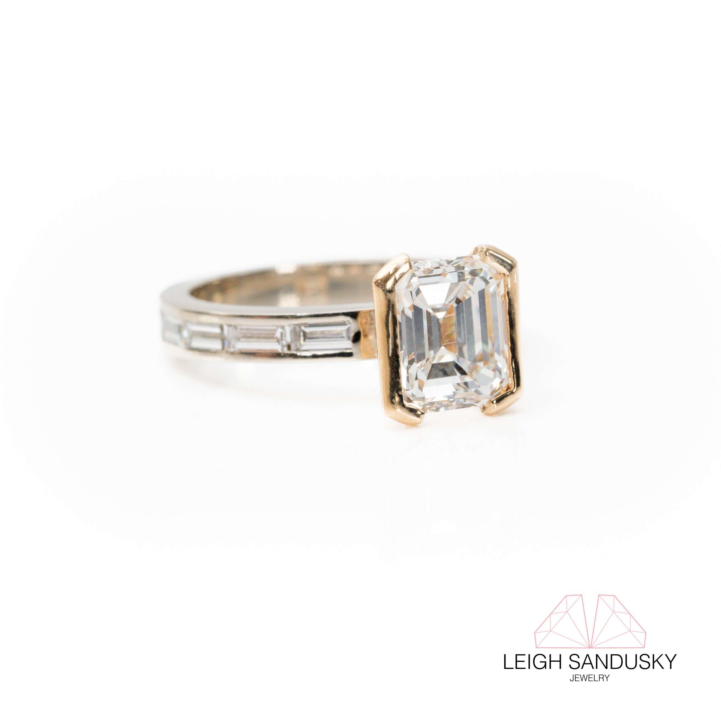 Emerald cut diamond half bezel two tone engagement ring