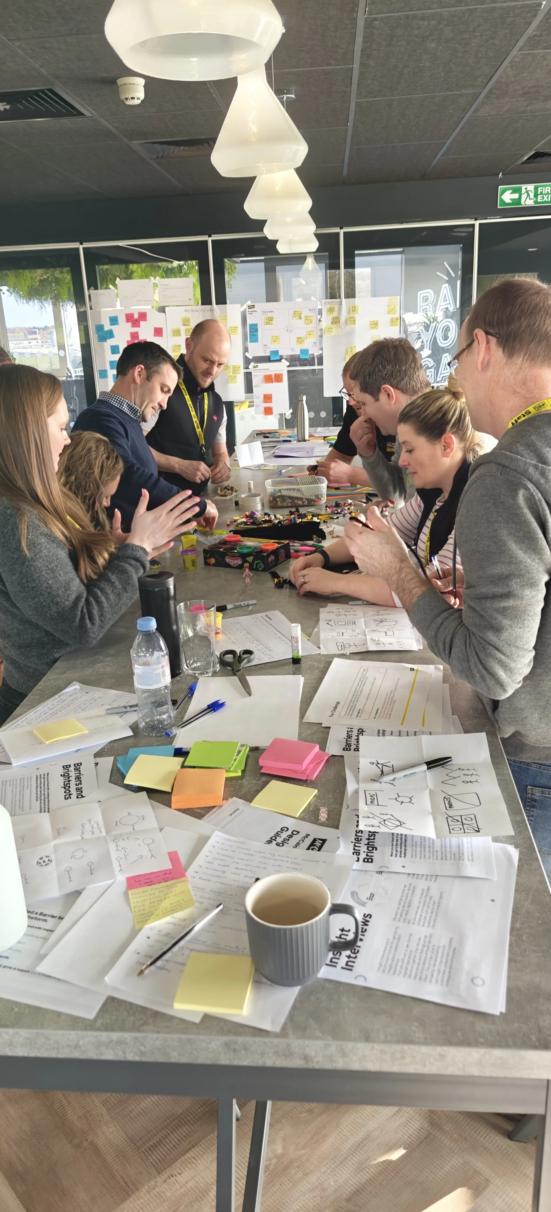Group of people collaborating and co-creating across table