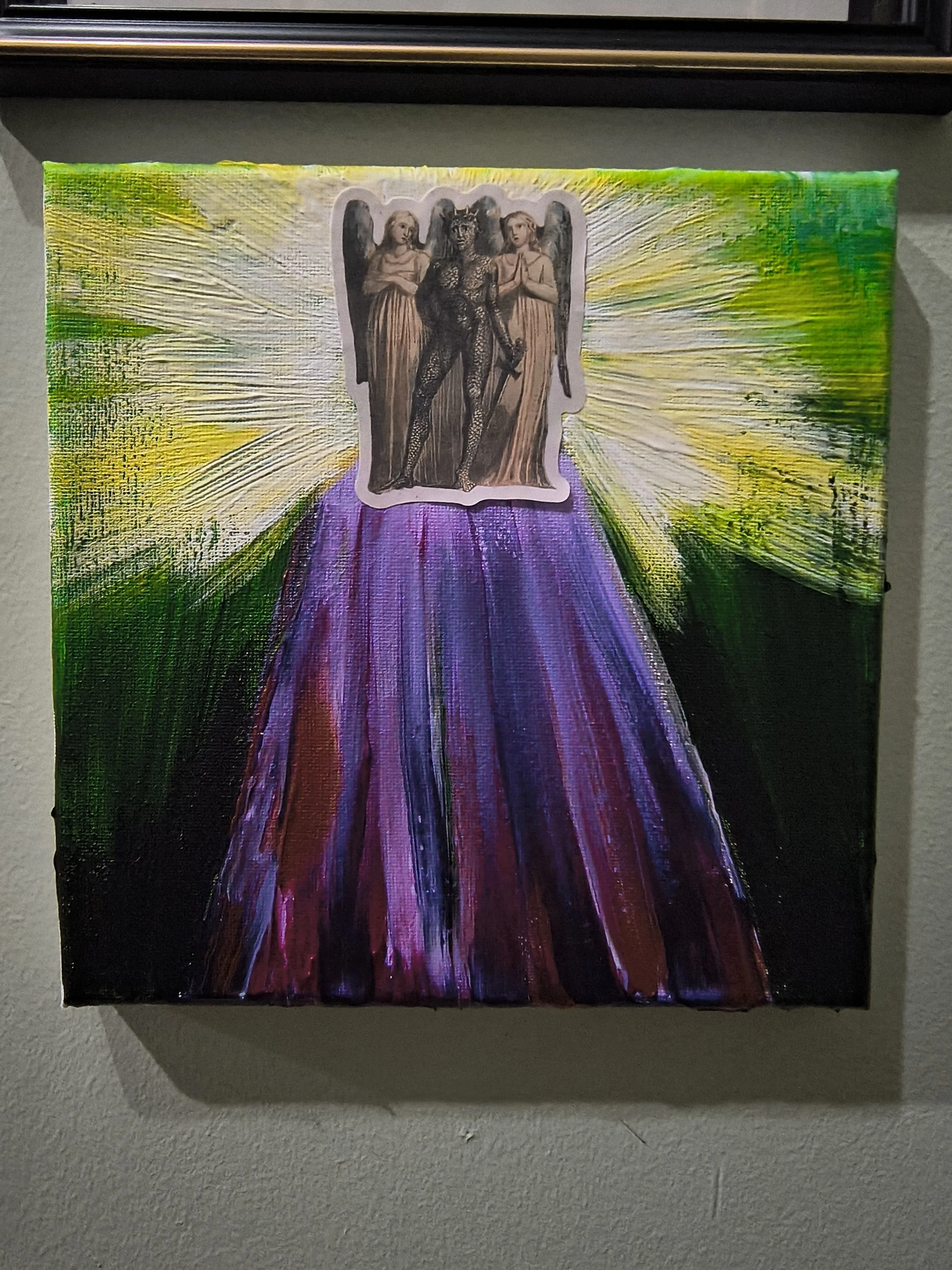 A colorful painting with a central collage of three figures: a black devil-like creature with wings and horns, flanked by two angelic figures with folded hands. The collage is set against a radiant background of yellow and green rays emanating from i