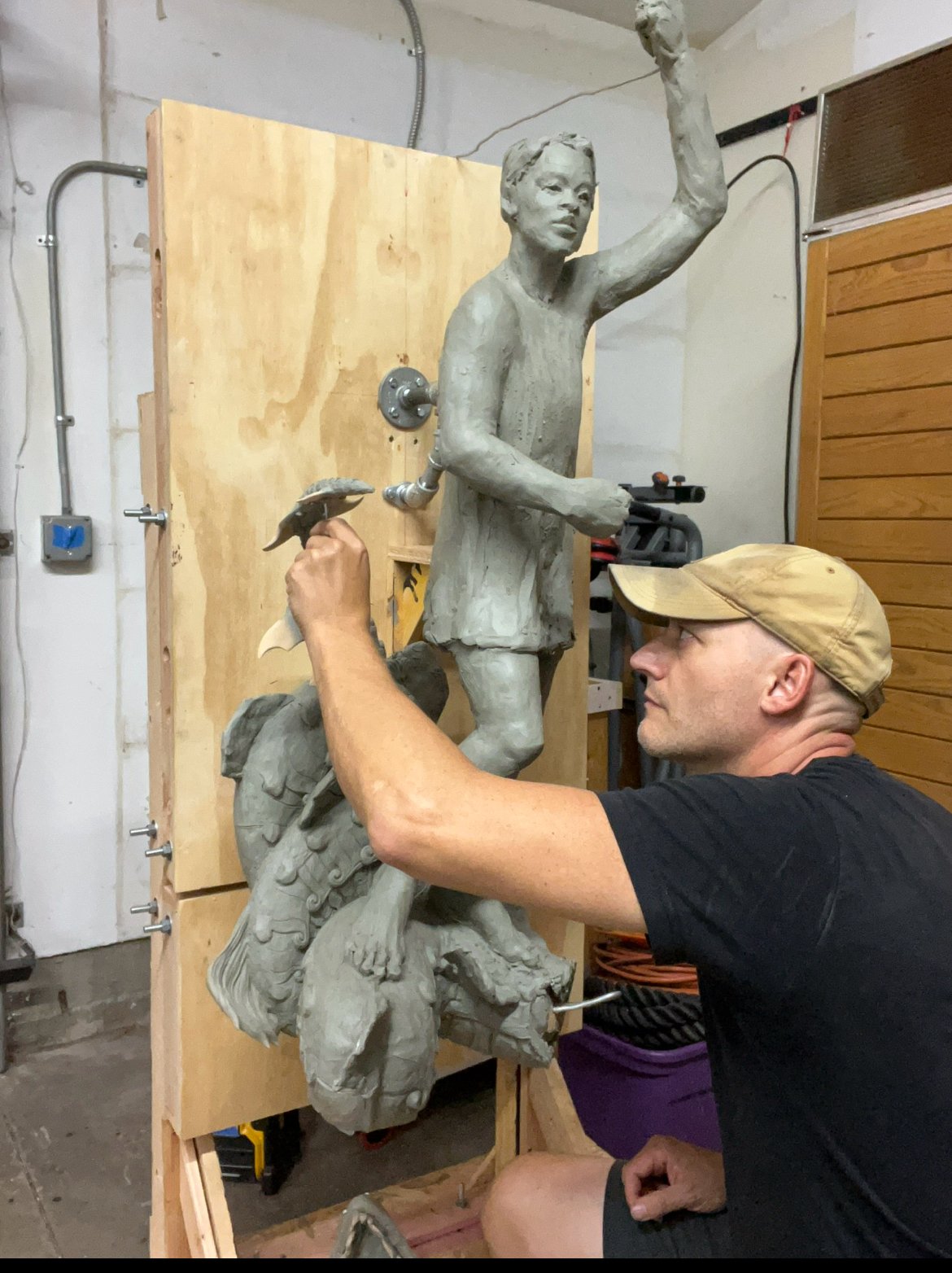 John Sumner sculpting a Bakunawa