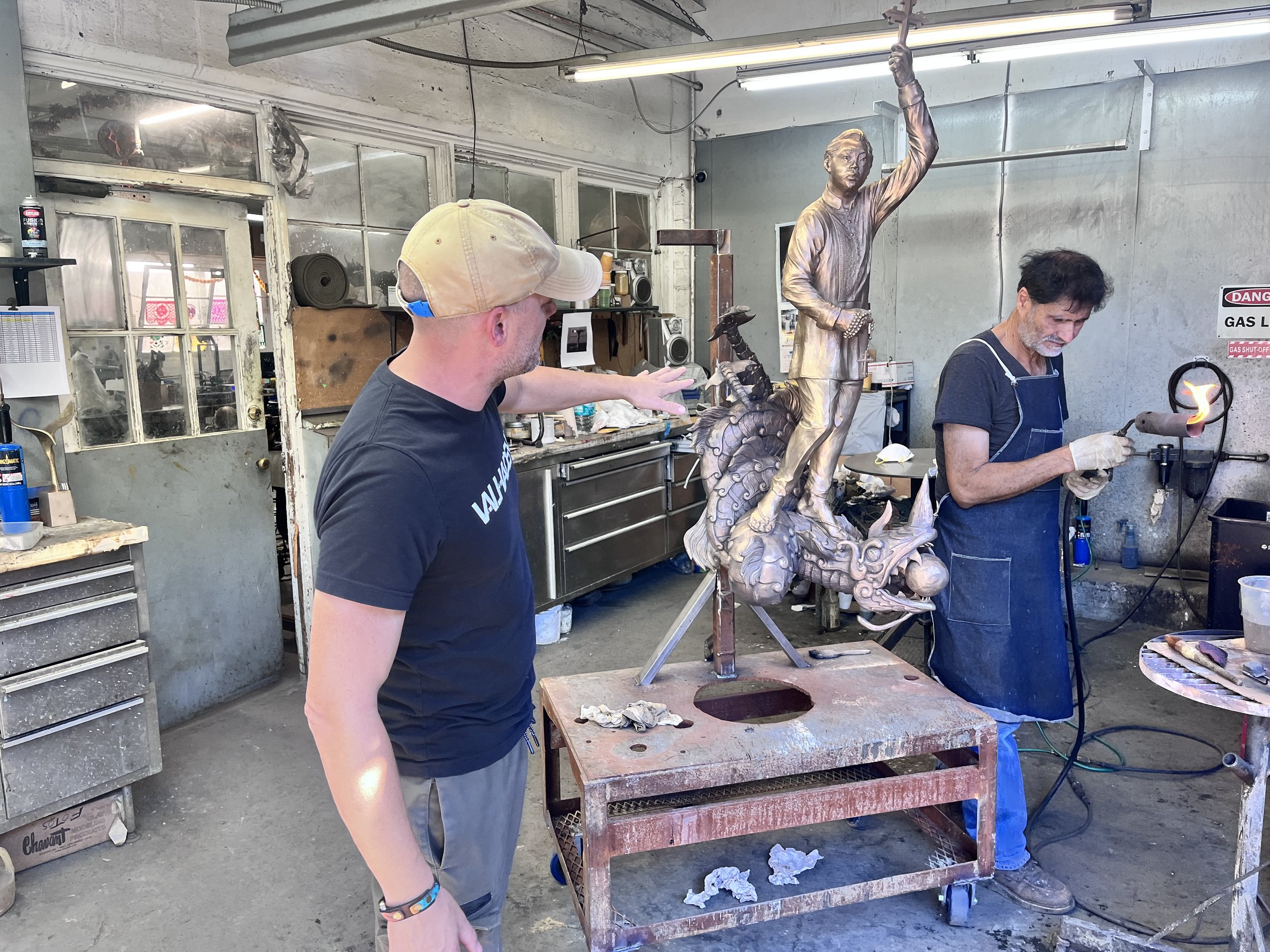 John Sumner working with sculpture foundry on the patina of the Bakunawa sculpture