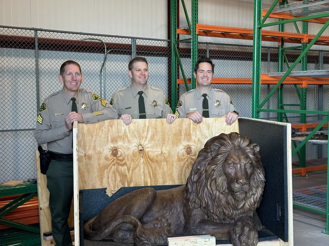 Fresno deputies with lion sculpture
