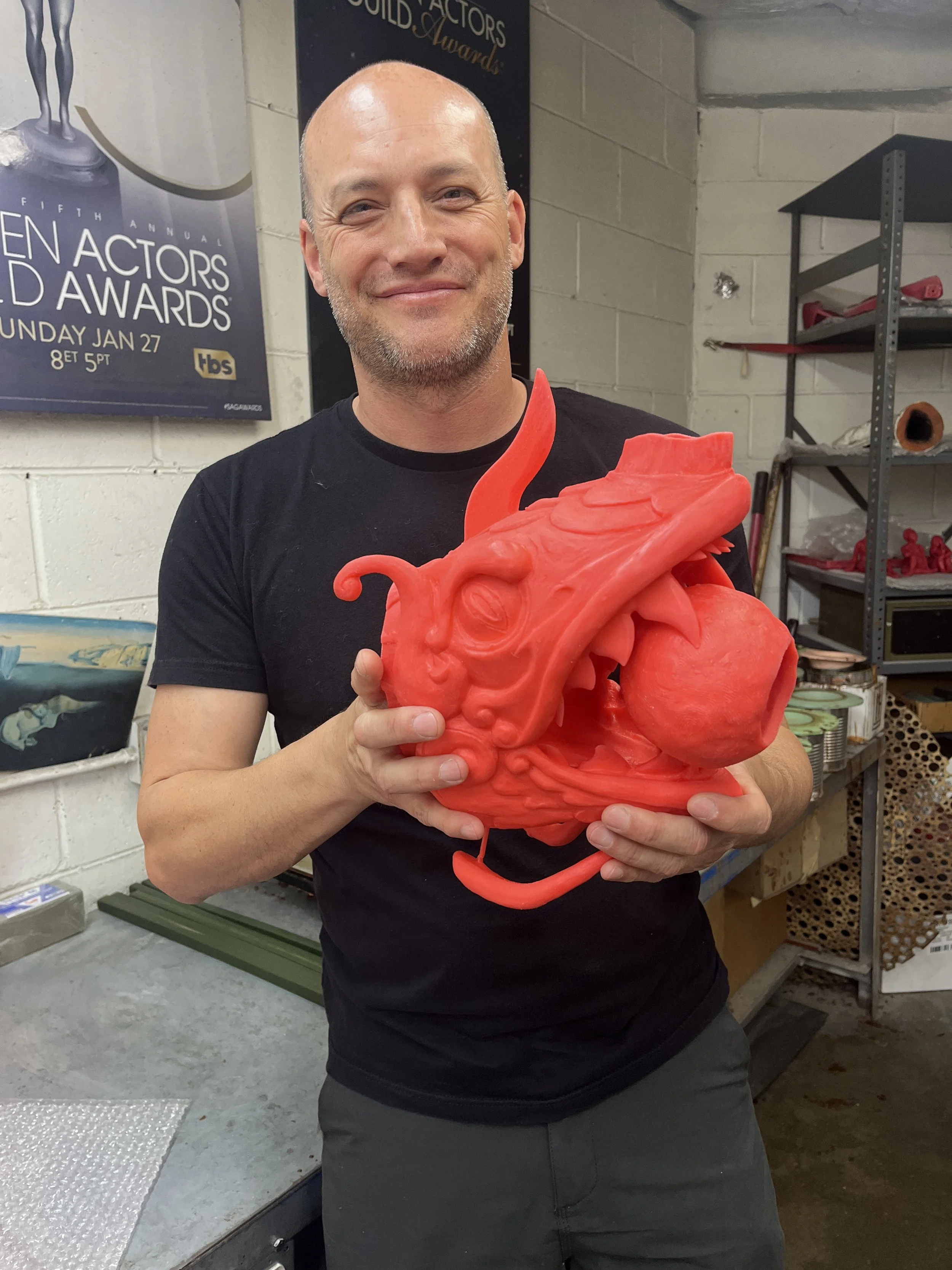 John sumner holding the wax cast of his bakunawa sculpture