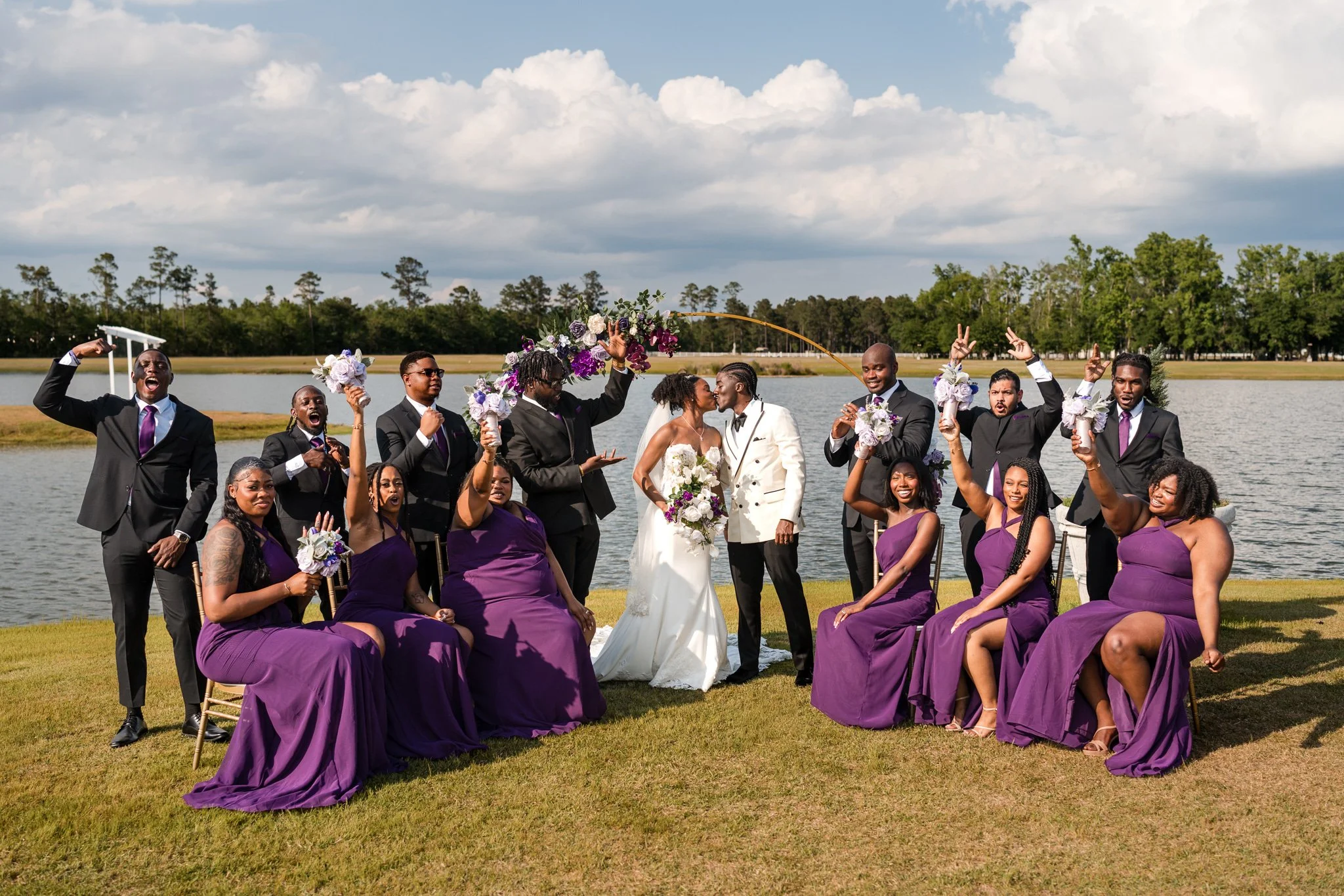 Full wedding party celebrating at Chateau 1800 lakefront wedding venue in Rincon GA near Savannah captured by Johannas J Photography