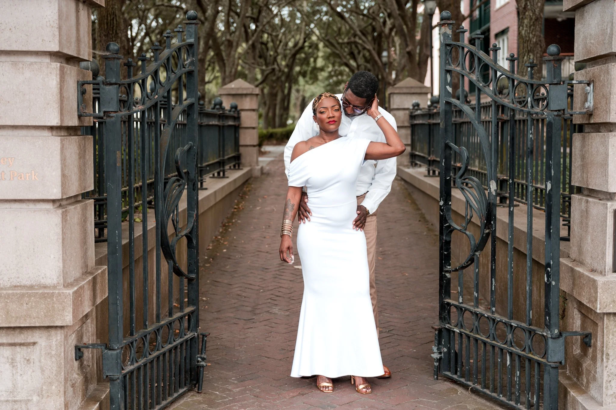 Bride-to-be April smiling with fiancé Willie during engagement portraits in downtown Charleston.