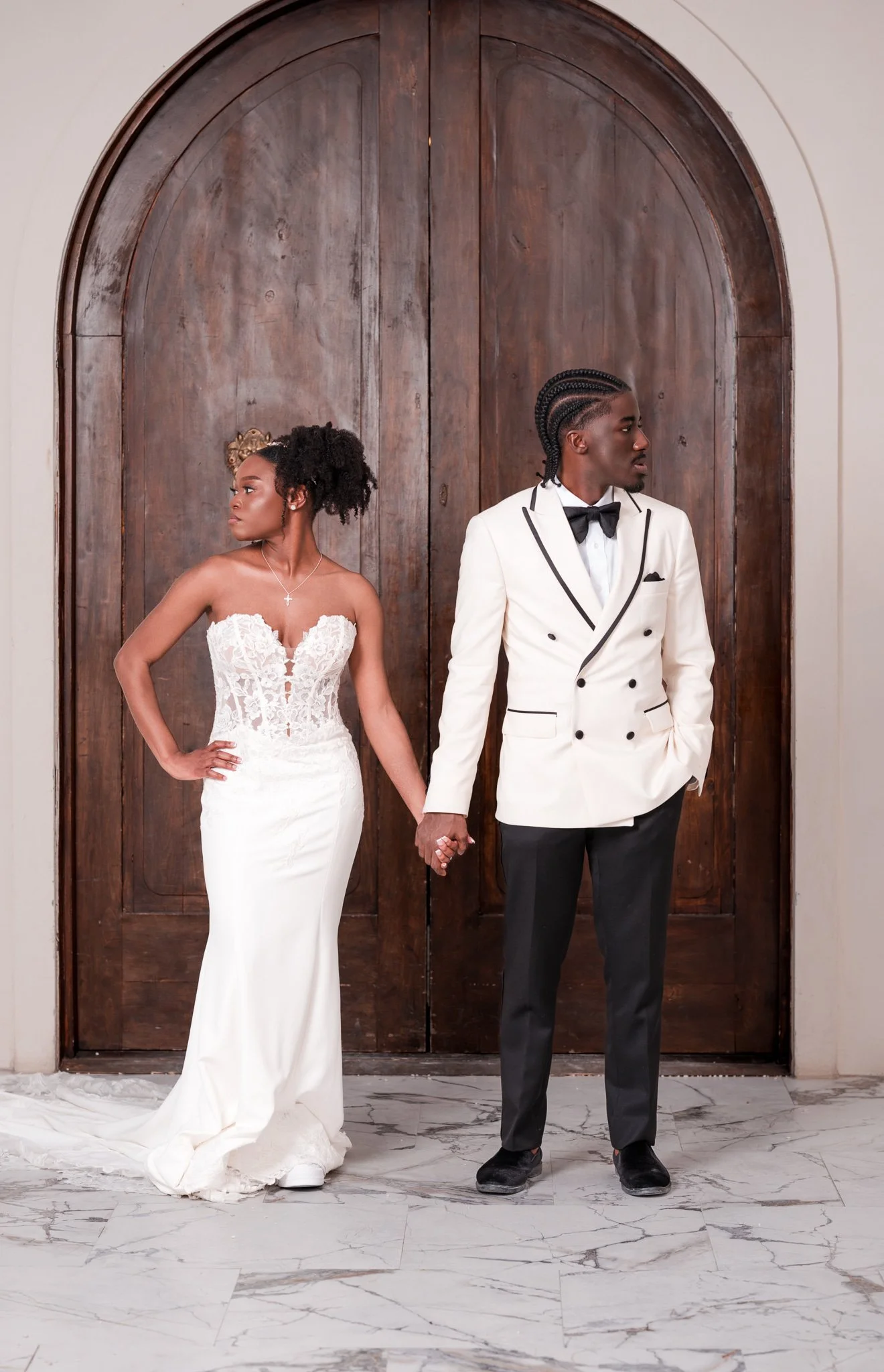 Bride and groom editorial portrait at arched wooden doors of Chateau 1800 wedding venue in Rincon GA near Savannah captured by Johannas J Photography