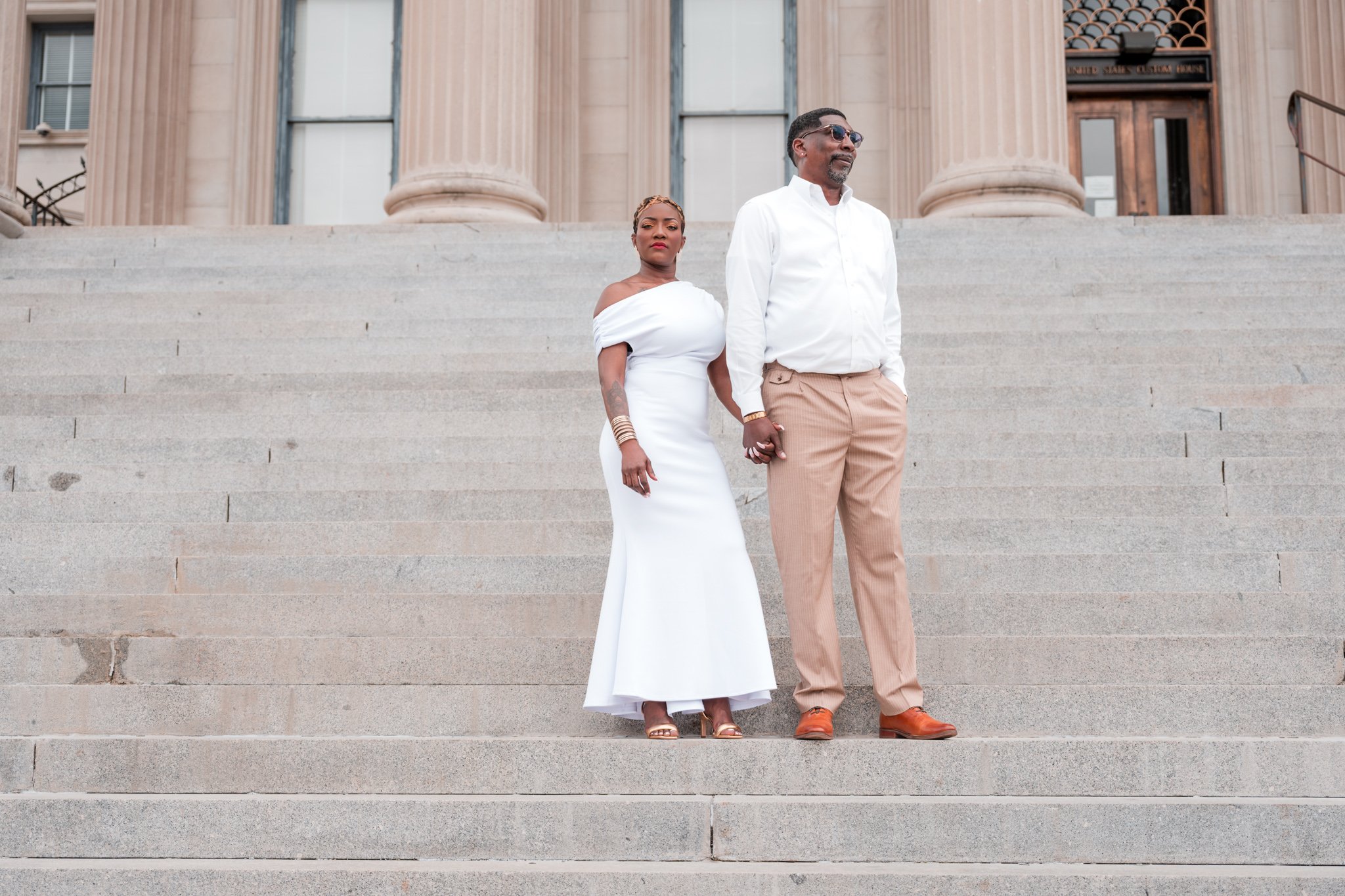 April and Willie posing together at The Custom House during their Charleston engagement session.