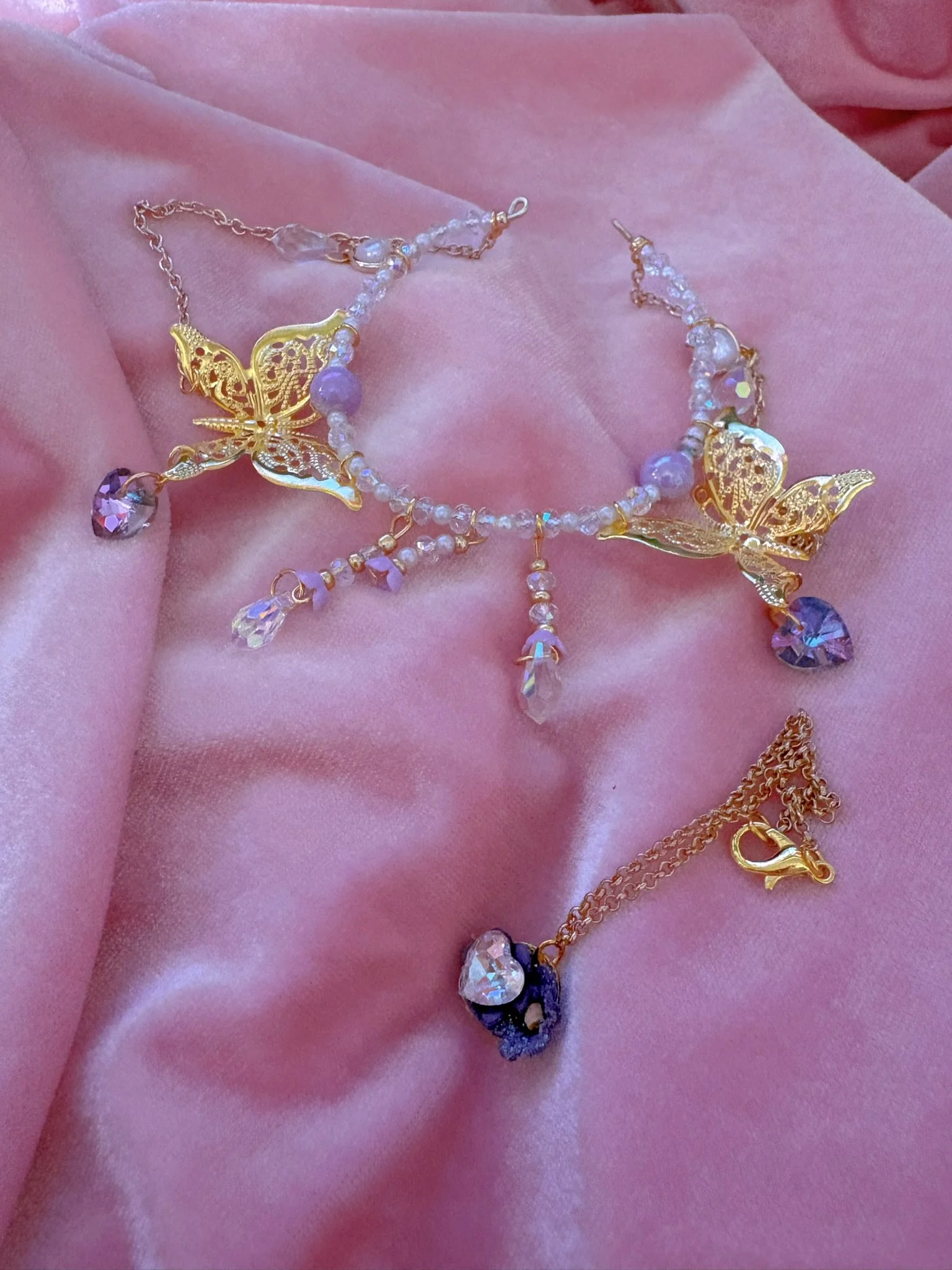 $35.00. 

Crystal and pearl crown with dangling lavender crystal hearts. Includes matching crystal heart and flower necklace. 

Adjustable, best fits dolls with size 6/7 through size 8/9 heads.