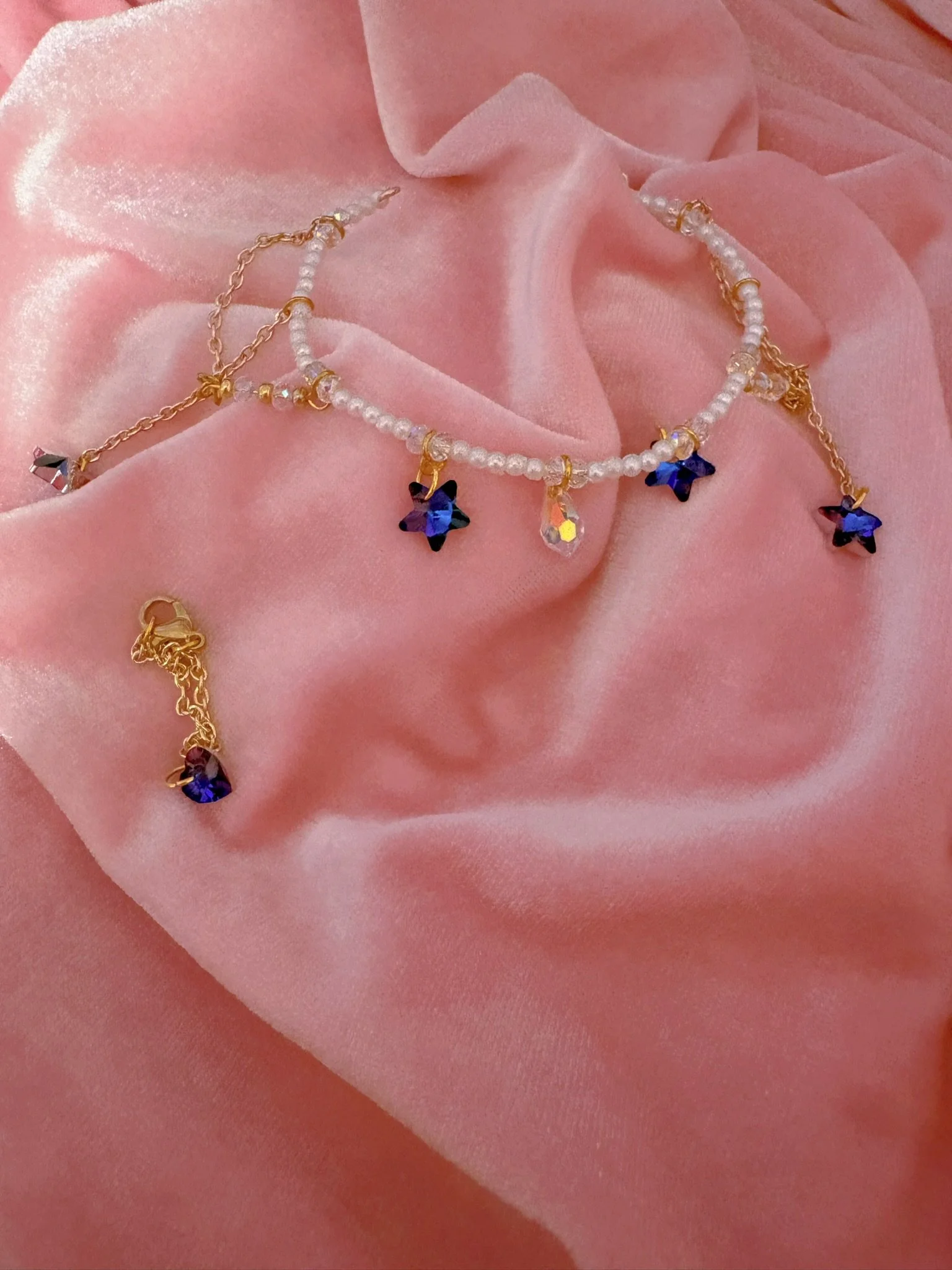 $20.00. 

Crystal bead and pearl tiara with dangling crystal star and gold chain details. Includes matching crystal heart necklace. 

Adjustable, best fits dolls with size 6/7 through size 8/9 heads.