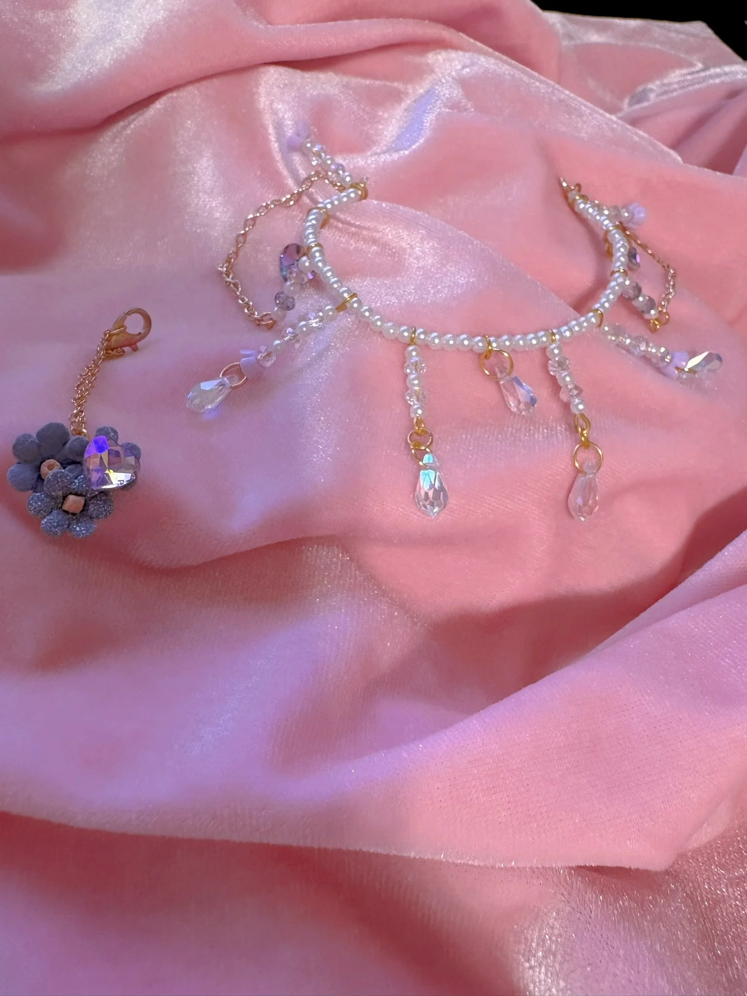 $30.00. 

Crystal bead and pearl tiara with dangling crystal and gold chain details. Includes matching crystal heart and flower necklace. 

Adjustable, best fits dolls with size 5/6 through size 7/8 heads.