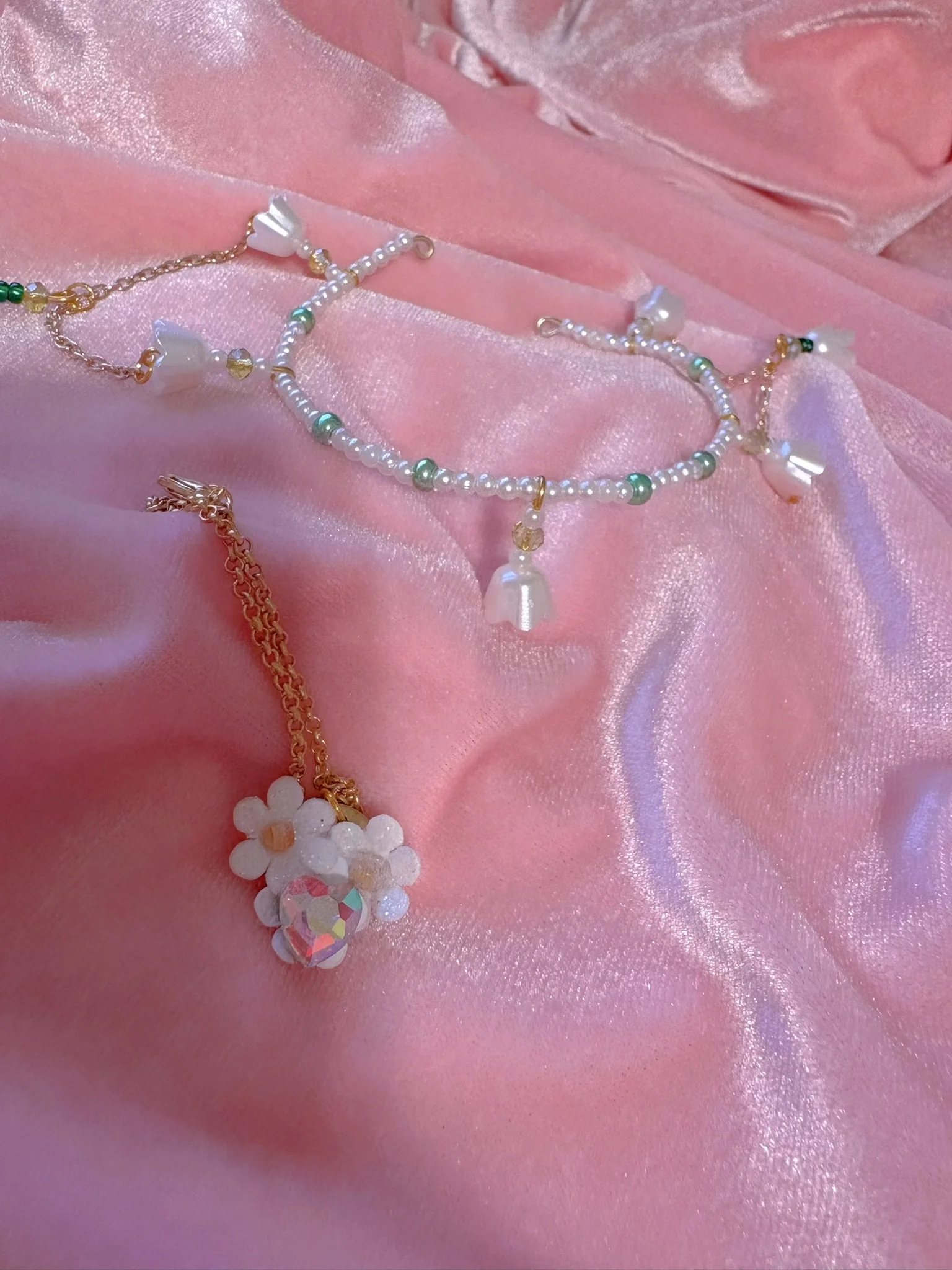 $20.00. 

Crystal bead and pearl tiara with dangling flower bead and gold chain details. Includes matching crystal heart and flower necklace. 

Adjustable, best fits dolls with size 7/8 through size 9/10 heads.