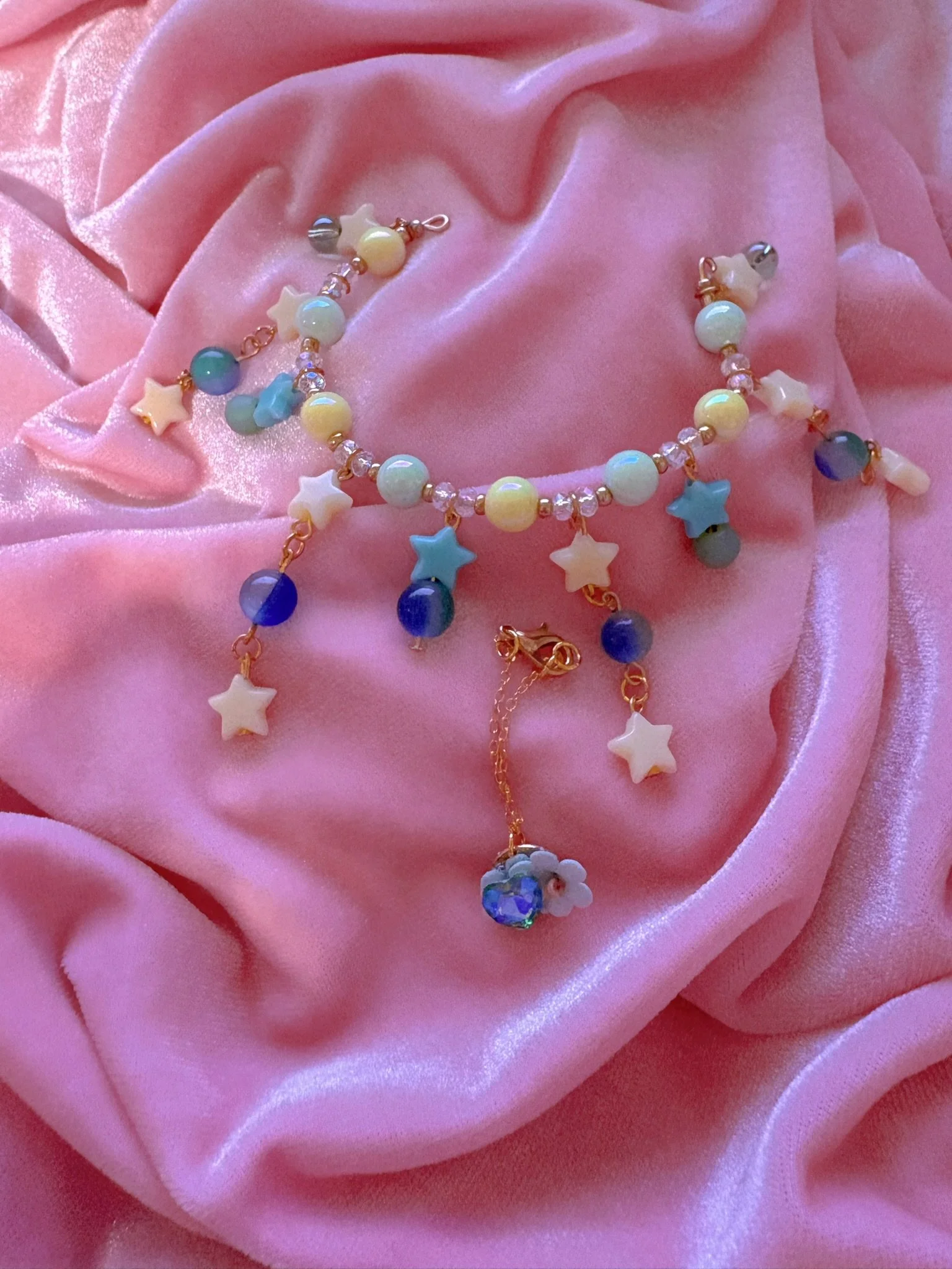 $20.00. 

Blue and green bead and star crown. Includes matching crystal heart and flower necklace. 

Adjustable, best fits dolls with size 6/7 through size 8/9 heads.