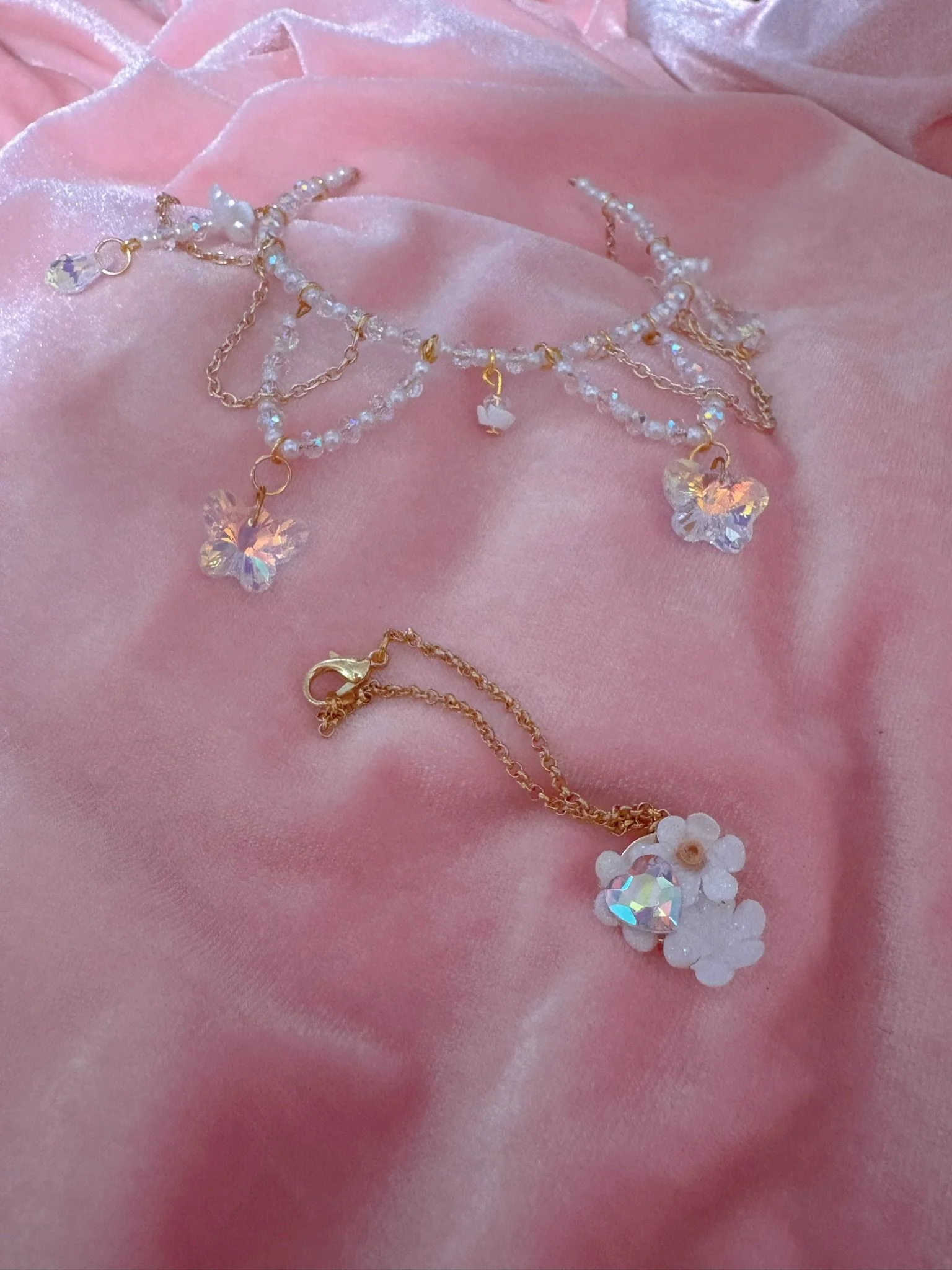 $35.00. 

White rose crown with dangling crystal butterflies, beads, and gold chain details. Includes matching crystal heart and flower necklace. Customizable necklace option: select an accent crystal for necklace (contact for more information - seco