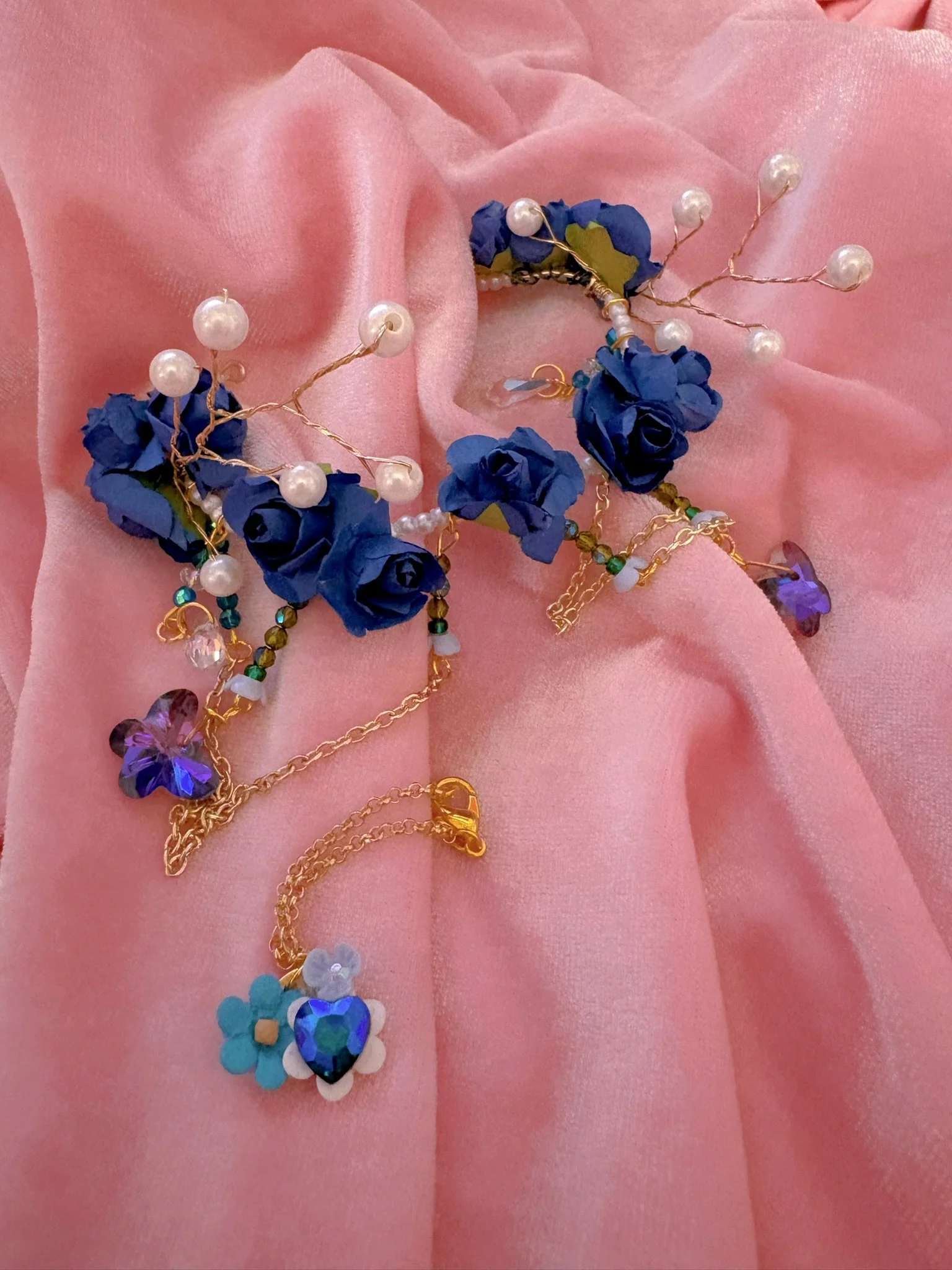 $35.00. 

Blue rose crown with pearl, crystal butterflies, and gold chain details. Includes matching crystal and flower necklace. 

Adjustable, best fits size 7/8 through size 9/10 heads.