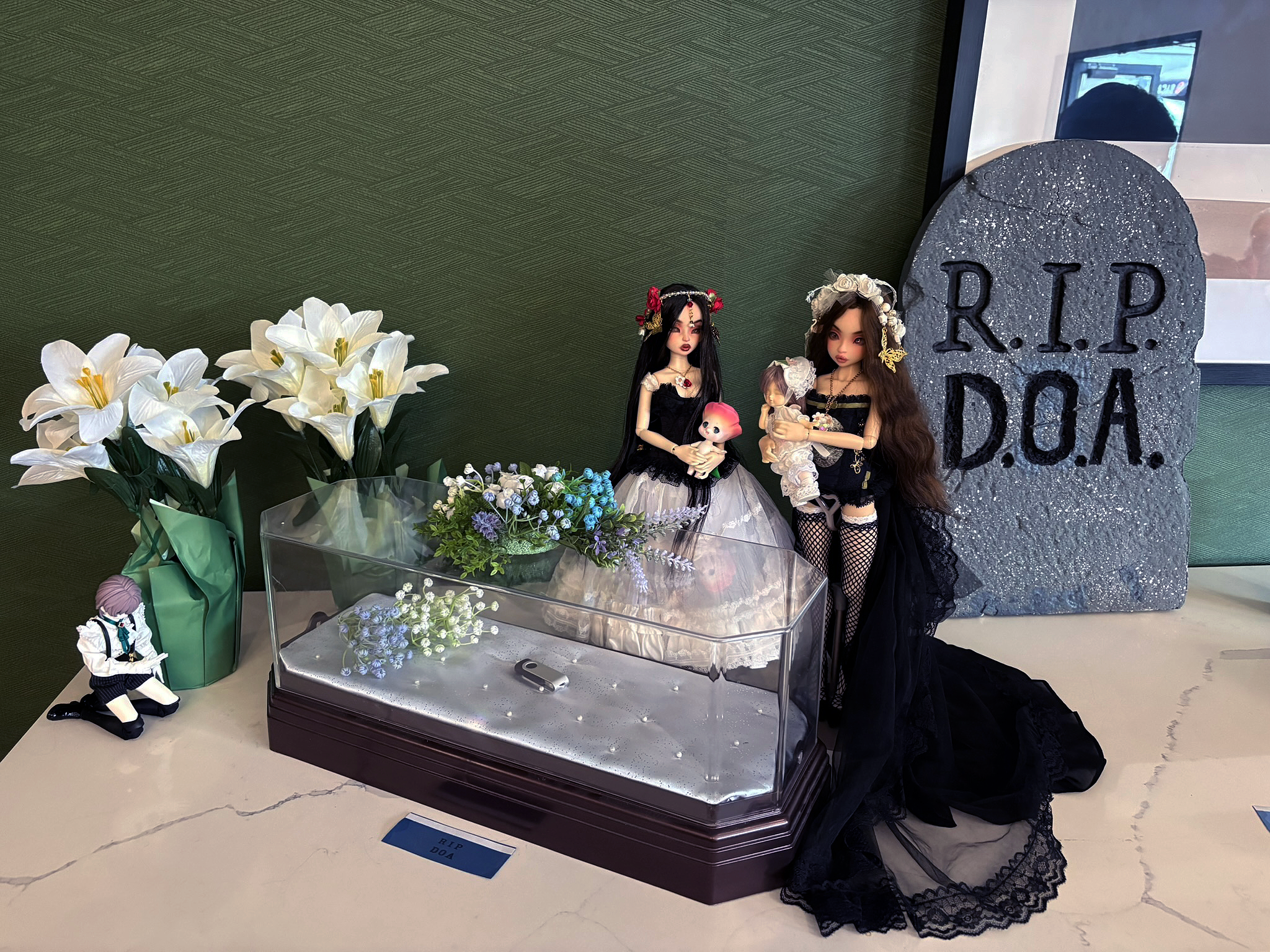 Asella Noble Dolls Raspberry and Asella Noble Dolls Rivanone at Resin Rose 2026 Den of Angels funeral, standing next to miniature coffin holding Cocoriang Rosette and Volks Rei-Tenshi BJD ball jointed doll