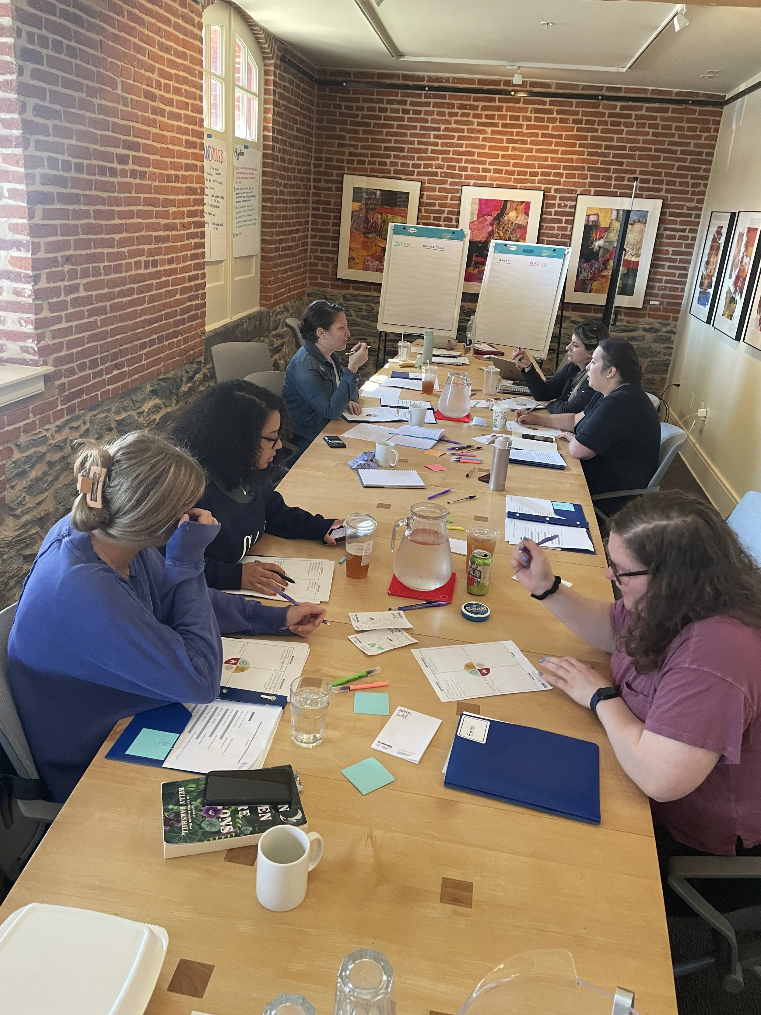 Participants have a conversation at a conference table.