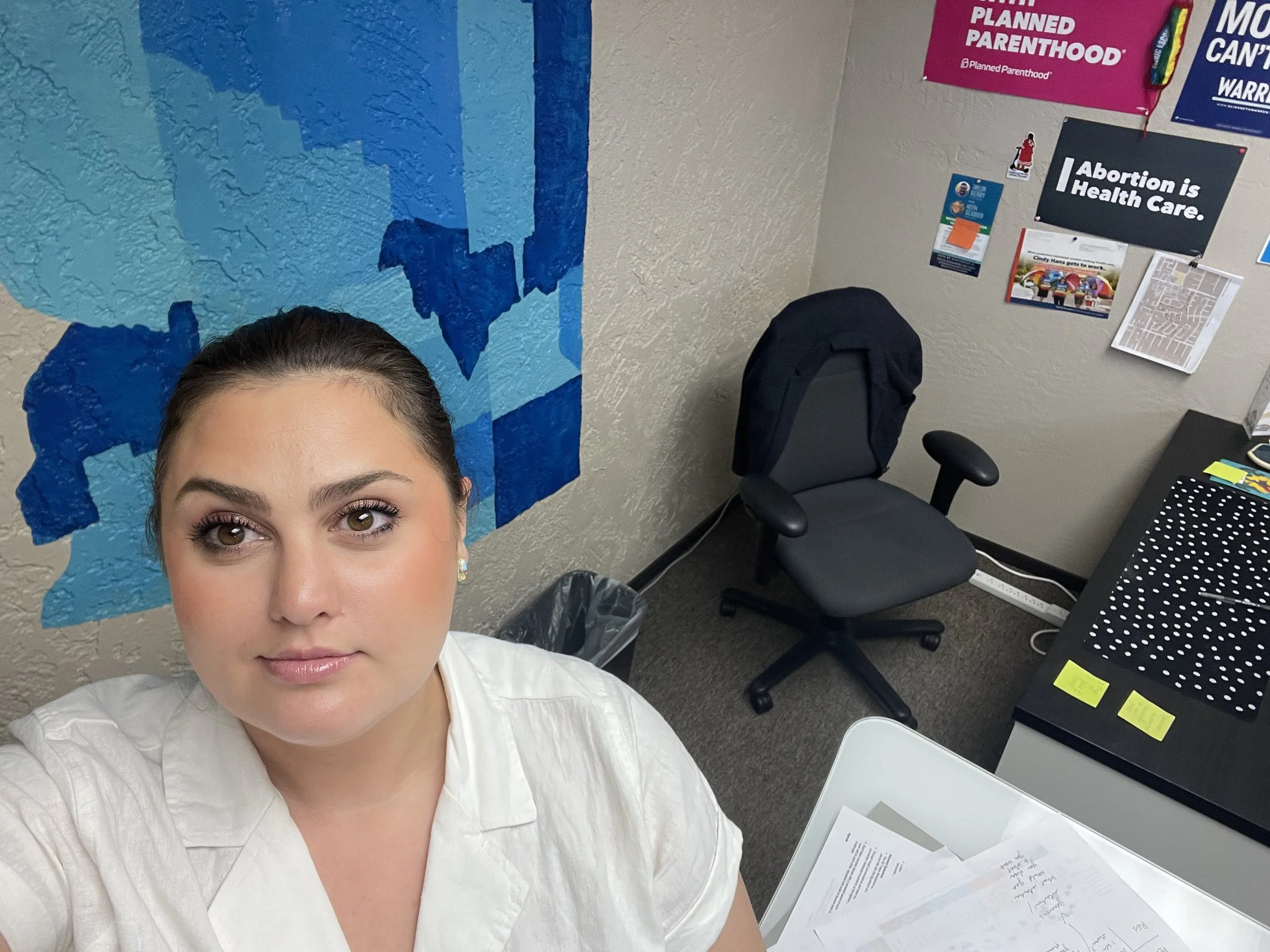 Sara takes a selfie in a campaign office.