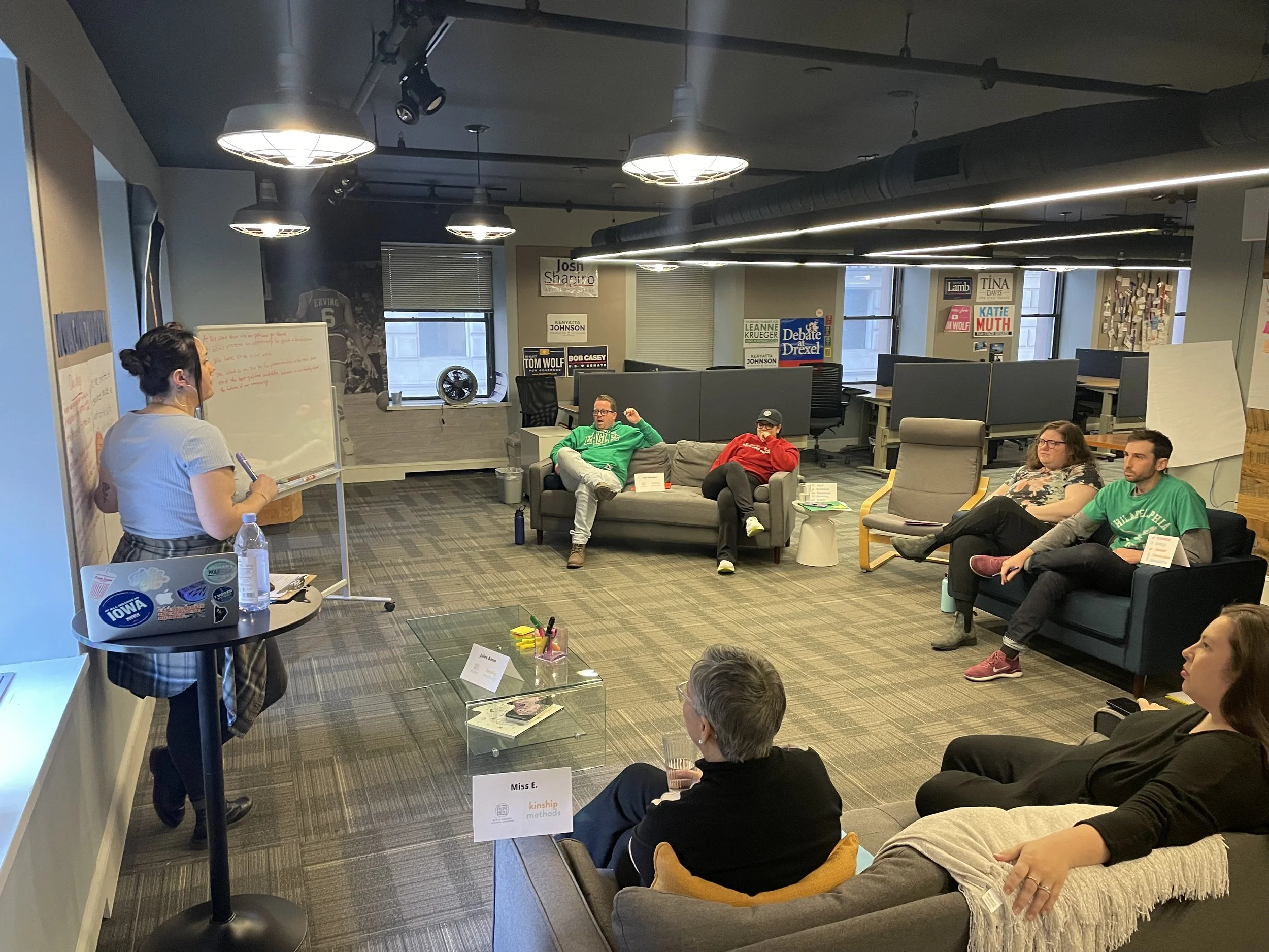 Kinship coach, Jules, facilitates a small in person session in an office in Philadelphia, PA.