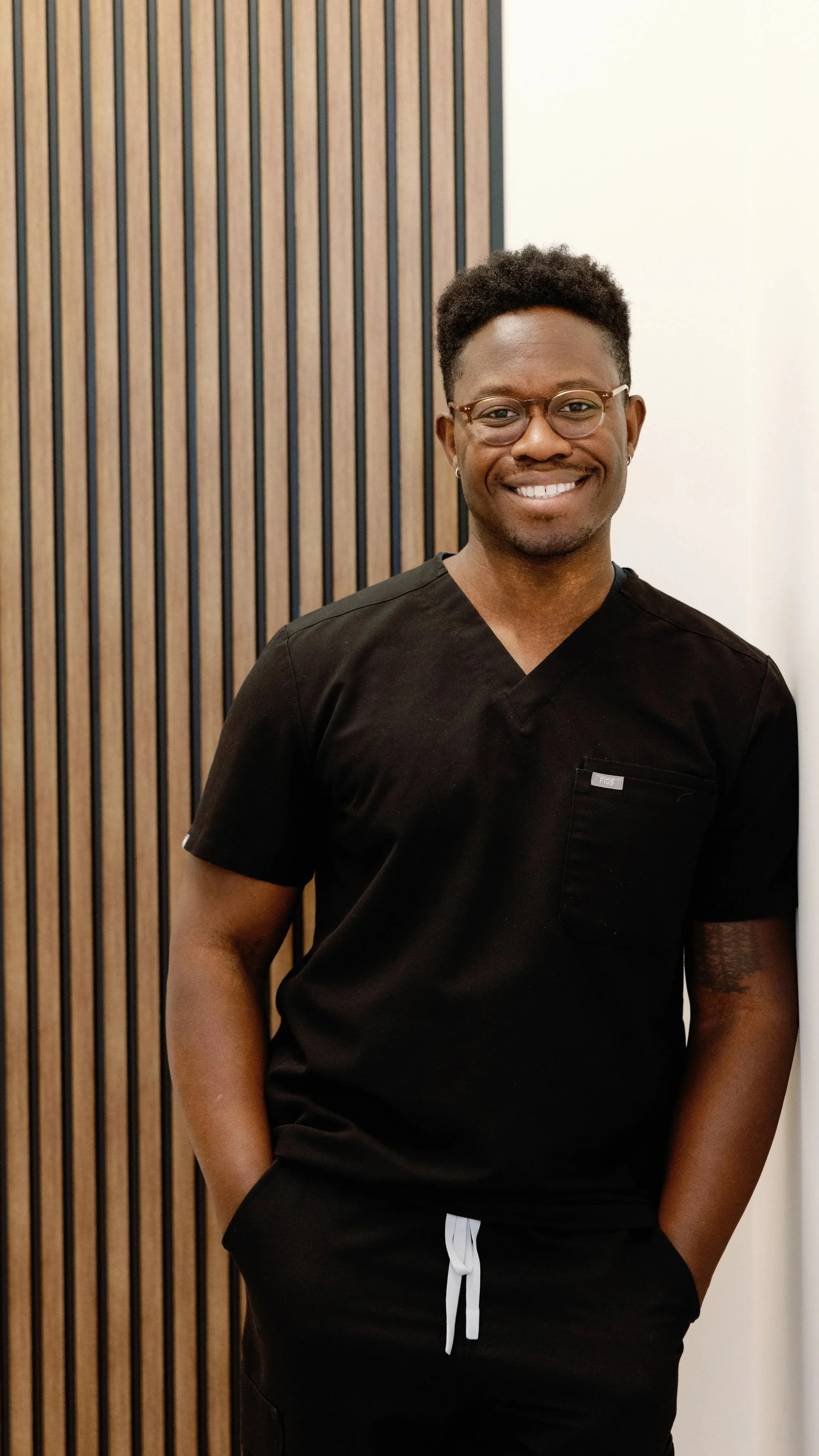 Dr. Sir Norman Melancon, an African American/black psychiatrist in scrubs uniform providing medication management in the San Jose Bay Area.