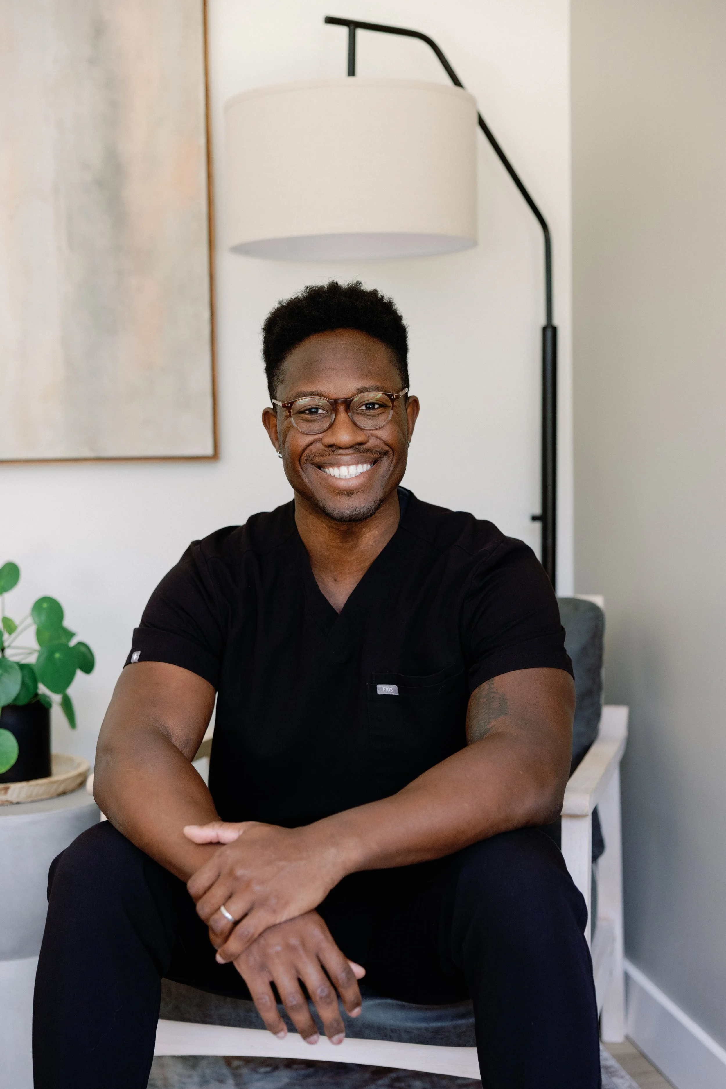 Dr. Sir Norman Melancon, an African American/black psychiatrist in scrubs uniform providing medication management in the San Jose Bay Area.