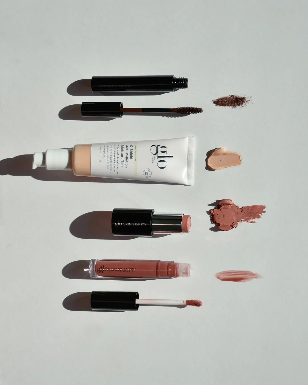 Five minutes. Four products. Skin that looks like skin.
C-Shield Moisture Tint, Cream Blush Stick, Conditioning Lip Gloss, Lash Lengthening Mascara in Dark Brown, your whole face, done before the coffee cools.