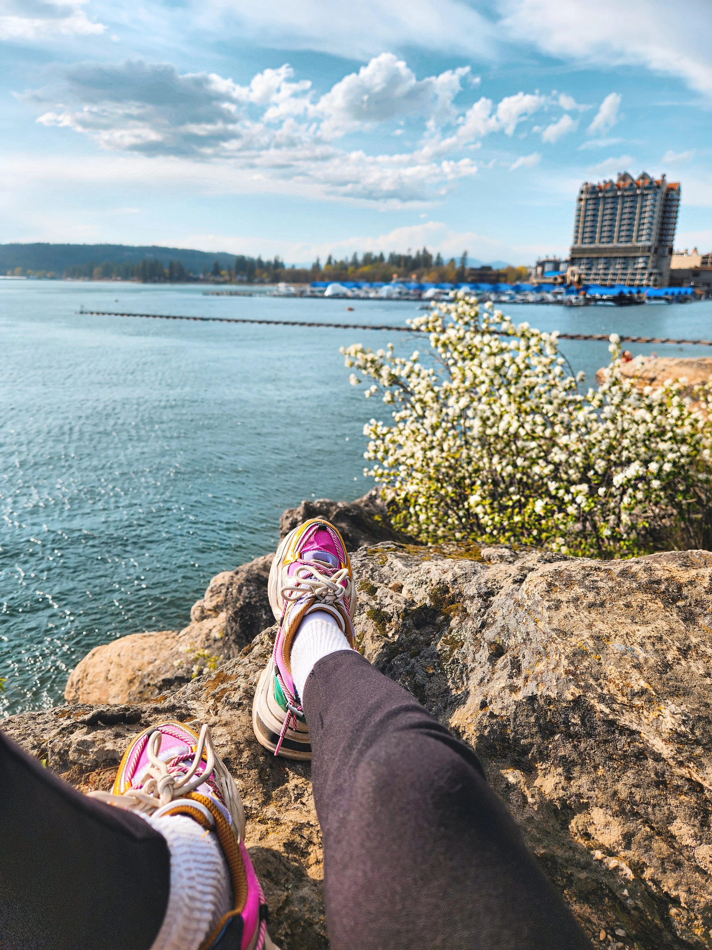 Kicks in the foreground, with the resort, springtime blooms, and a broad swathe of blue in the back