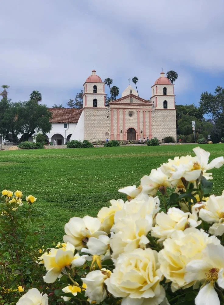 Old Mission Santa Barbara framed by elegant gold-white roses