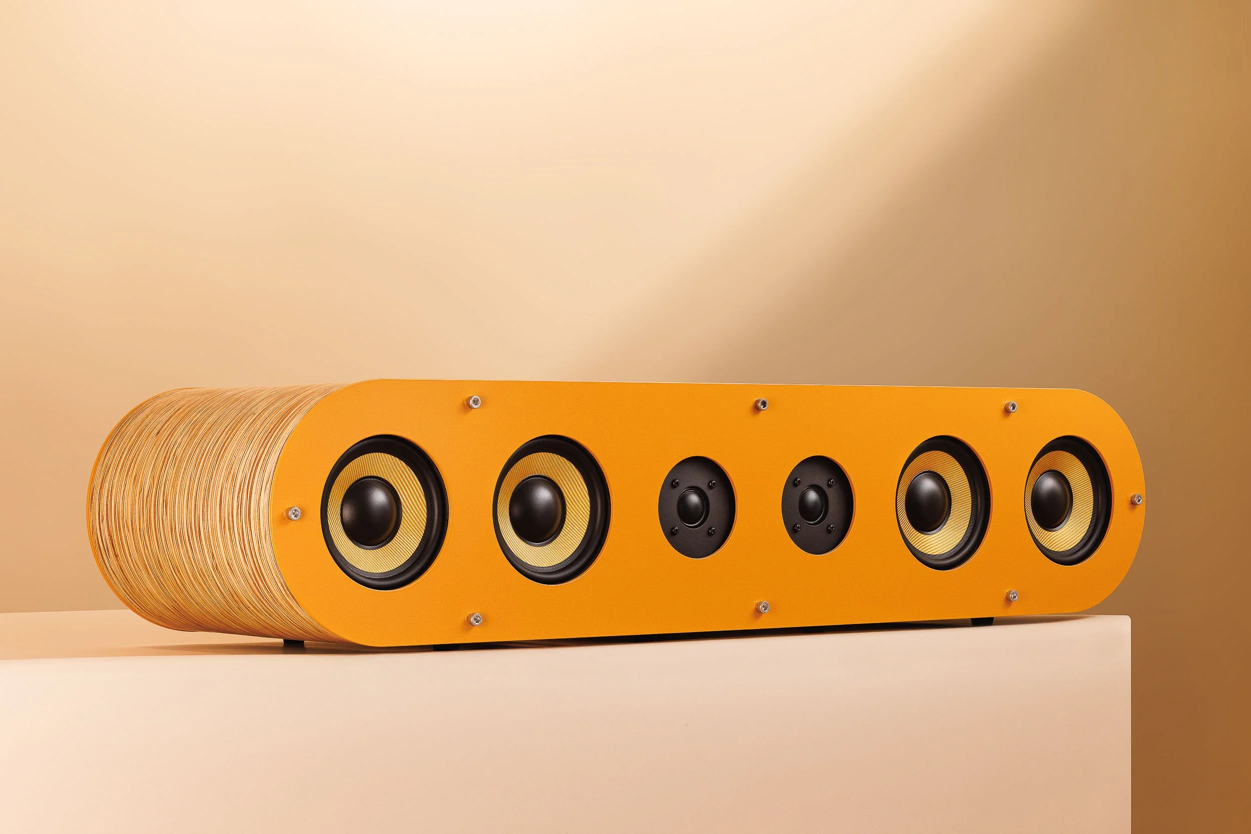 Fourier Acoustics Boomslang horizontal stereo speaker bar with amber baffle, six drivers, and layered wood enclosure